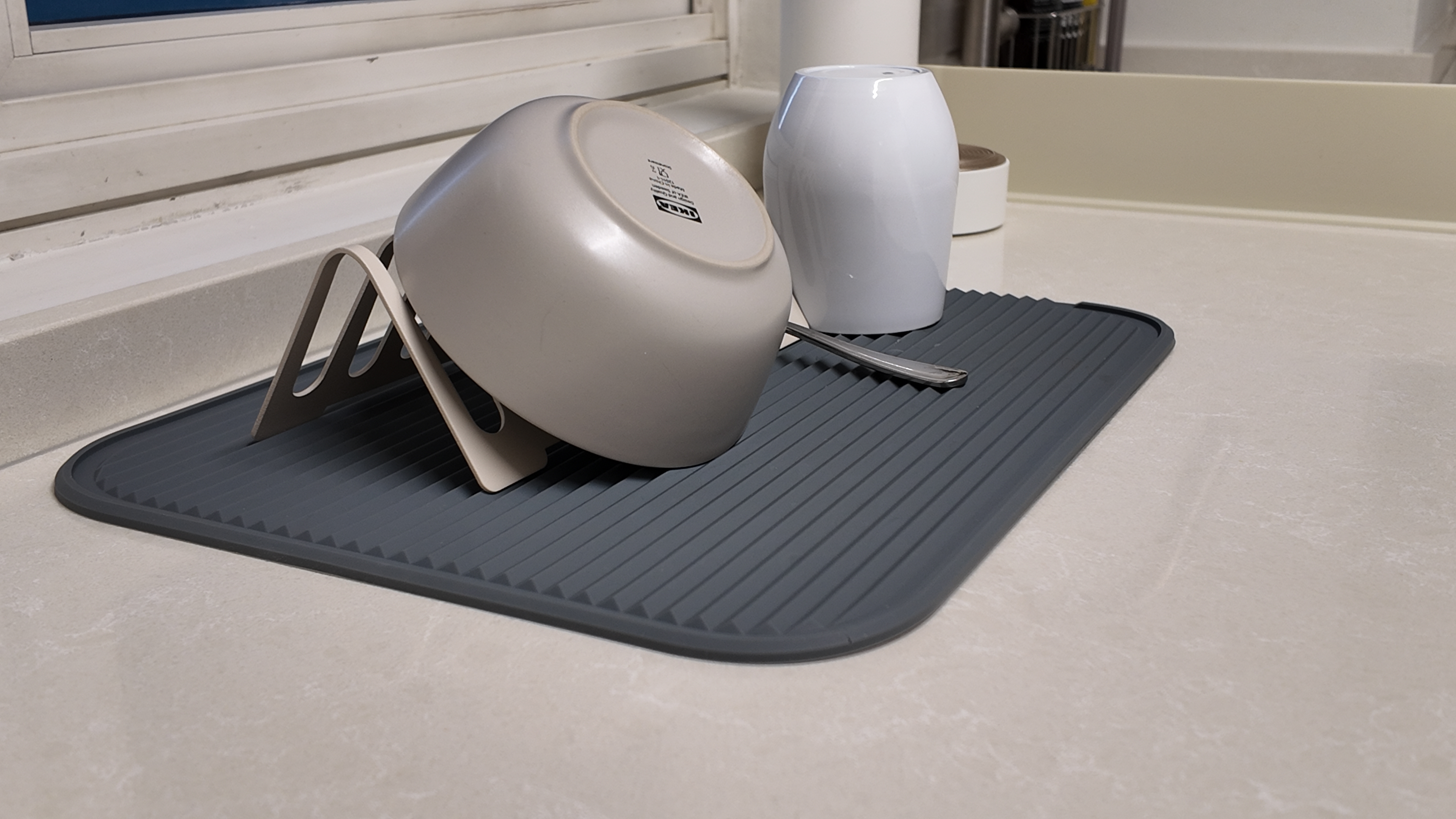 Our Simple U-Shape Kitchen: Maximising Space Without a Service Yard - Grey pot with handle, white container, black mat