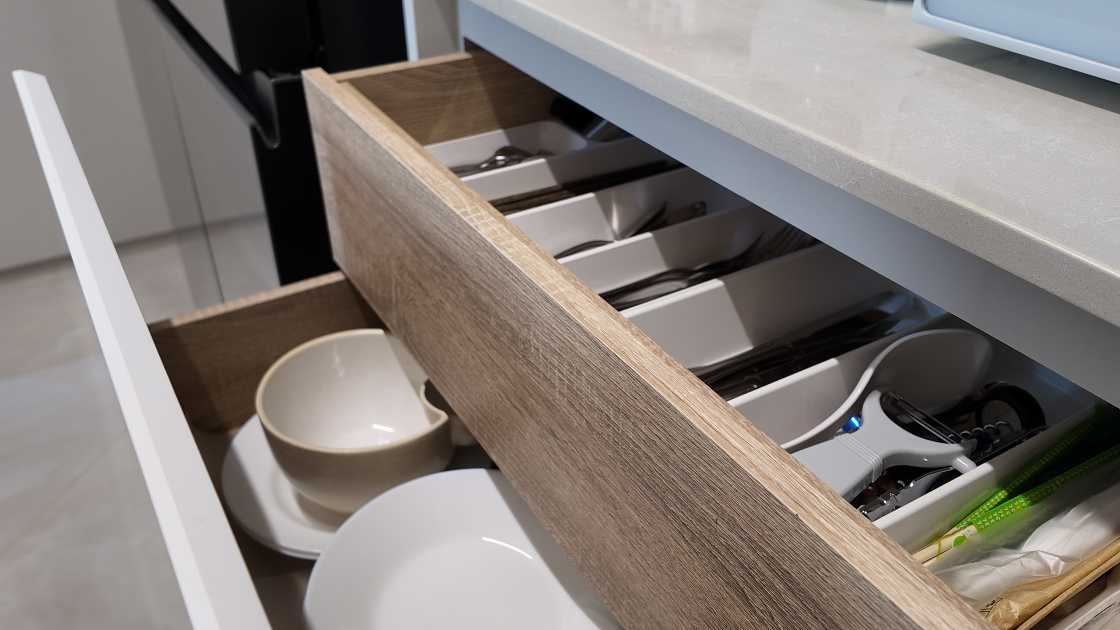 Our Simple U-Shape Kitchen: Maximising Space Without a Service Yard - Wooden kitchen drawer, neatly organized dishes, white
