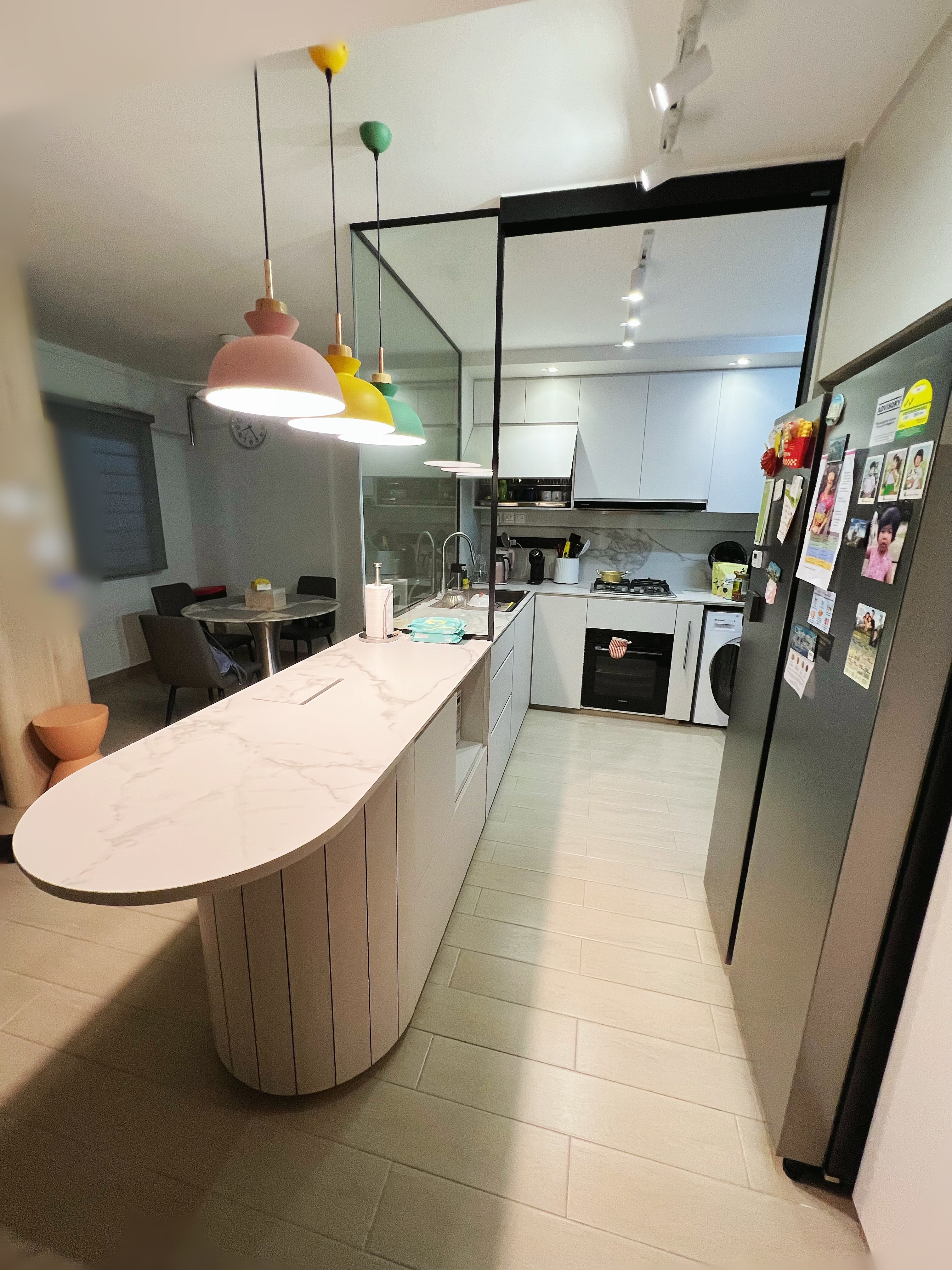 An all white kitchen separated  into wet and dry areas - Modern kitchen with marble countertop, pendant lights in pink