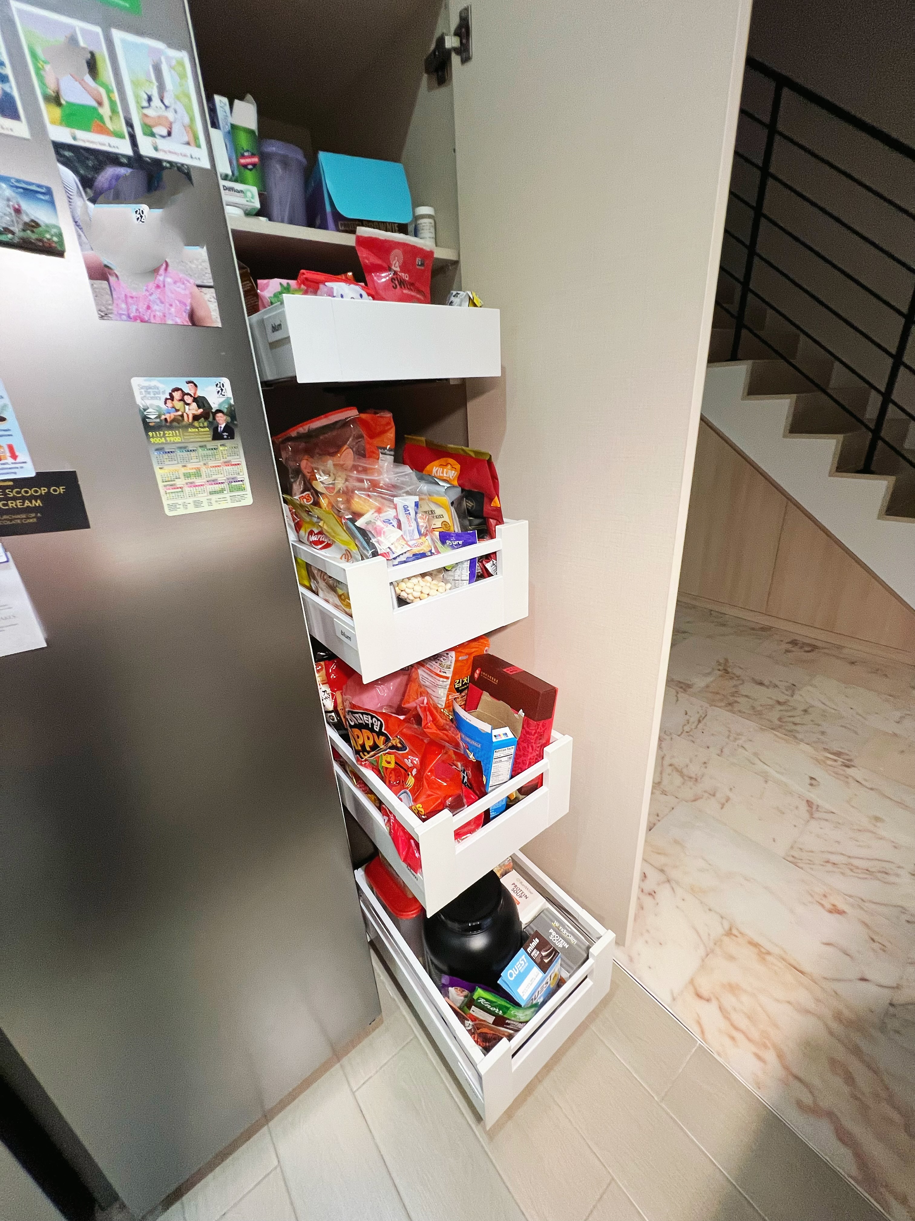 An all white kitchen separated  into wet and dry areas - Refrigerator drawer, food storage, organized pantry, white shelves