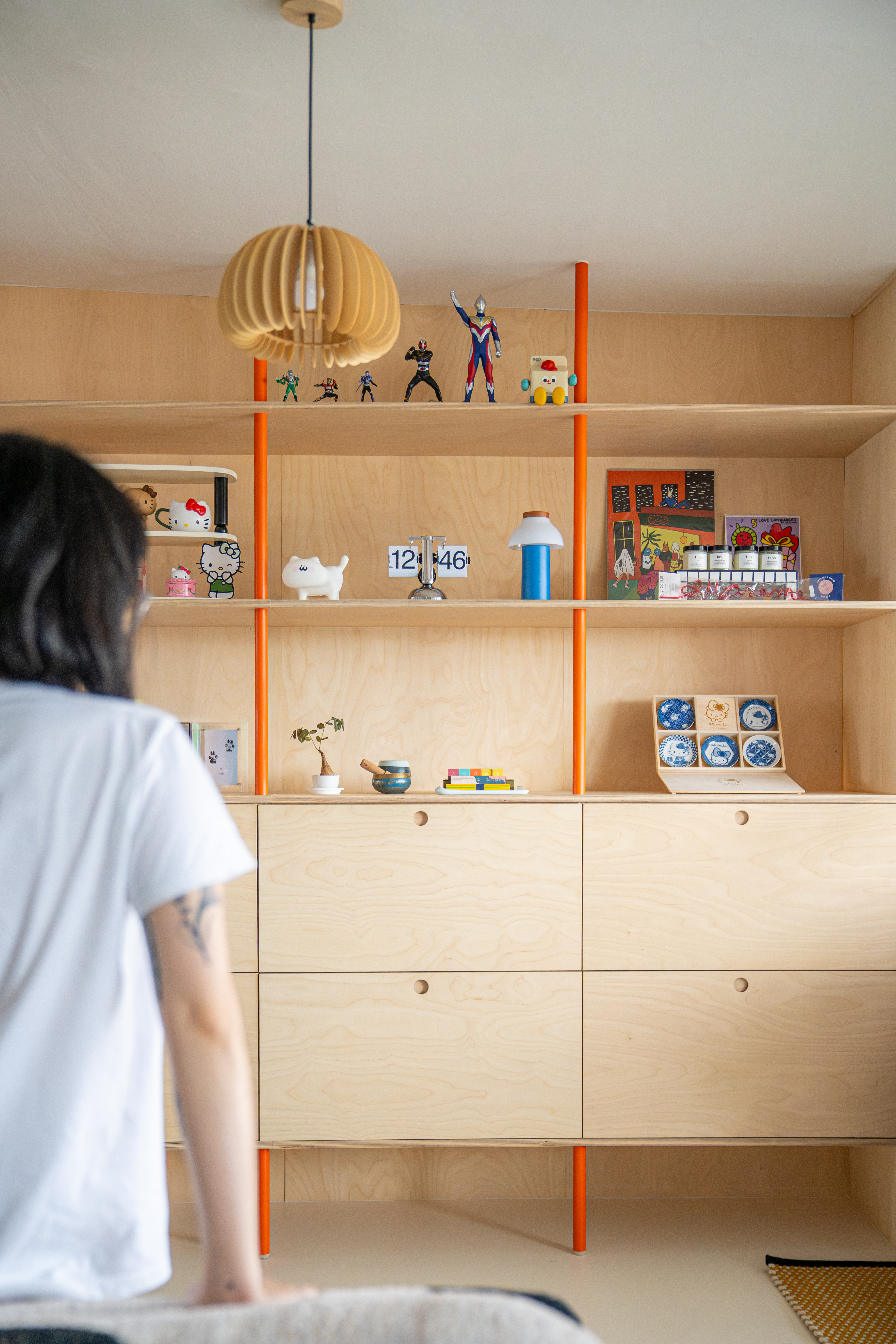 Our 2-in-1 Living Room: A space created for comfort and entertainment  - Wooden shelving unit, orange accents, minimalist