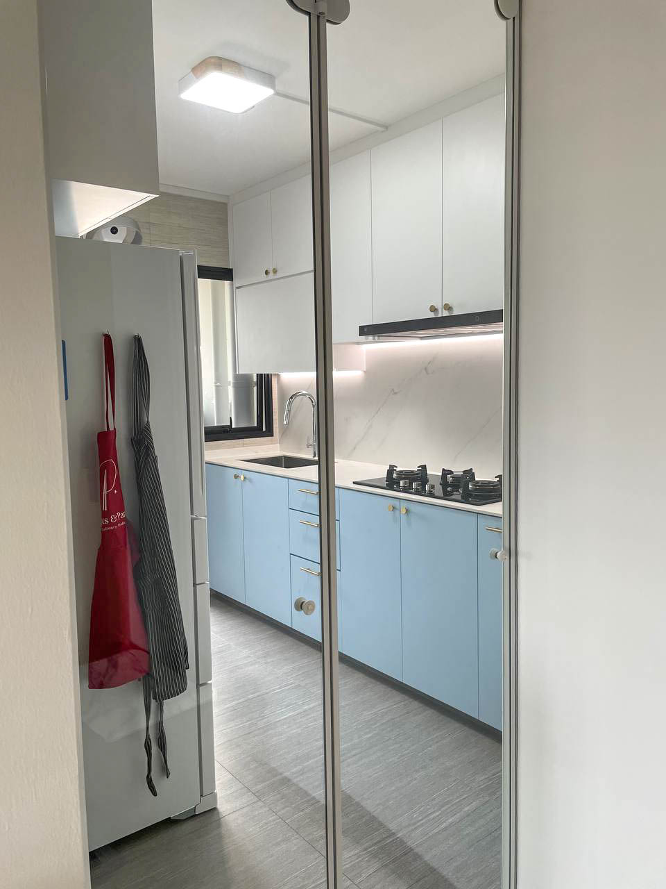 Revamping Our Kitchen: Creating a Clean, Coastal Kitchen - Modern kitchen with light blue cabinets, stainless steel