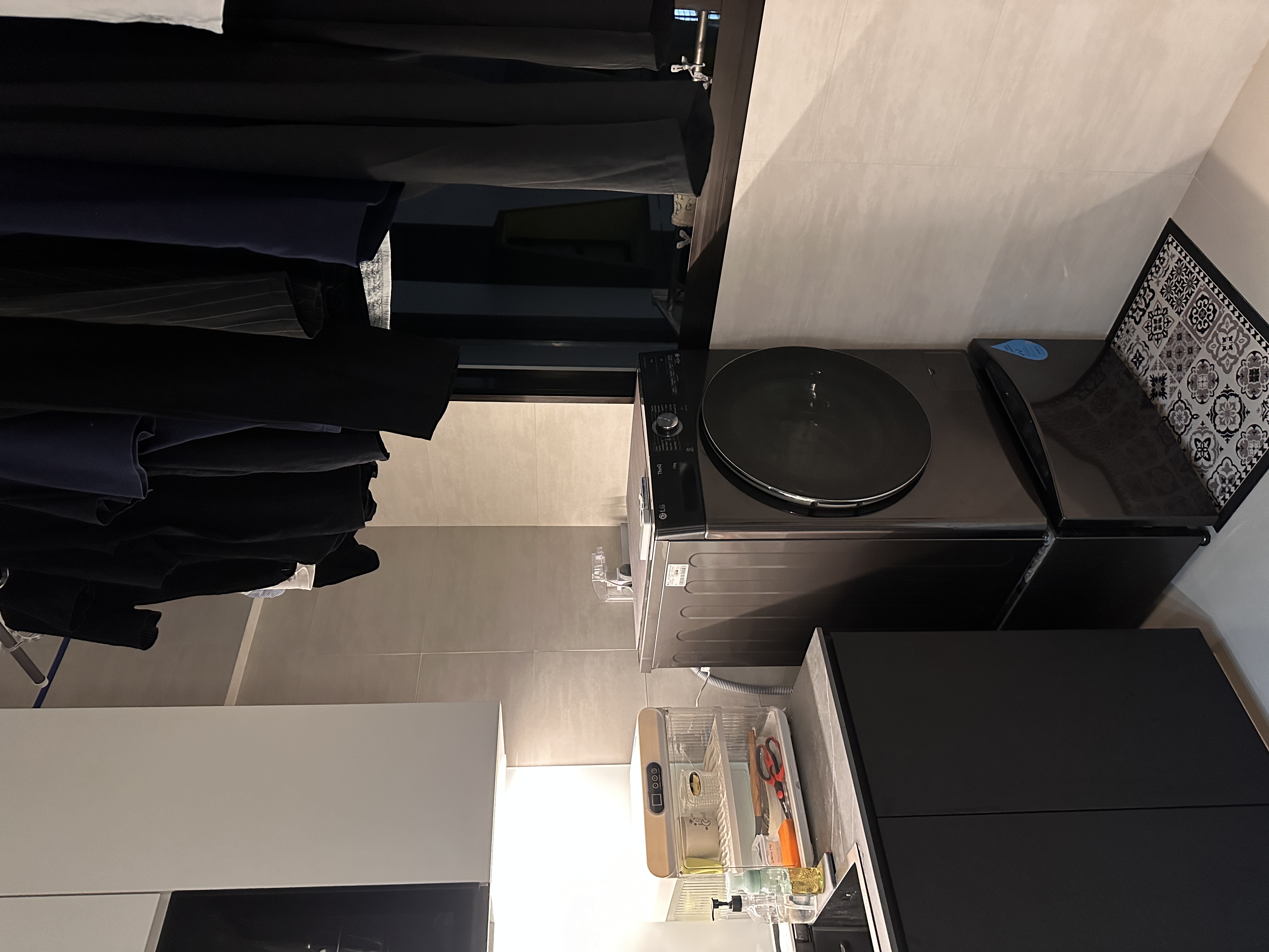 Efficient and Elegant: Our Monochrome Kitchen Design  - Black washing machine, modern design, top-loading, sleek surface