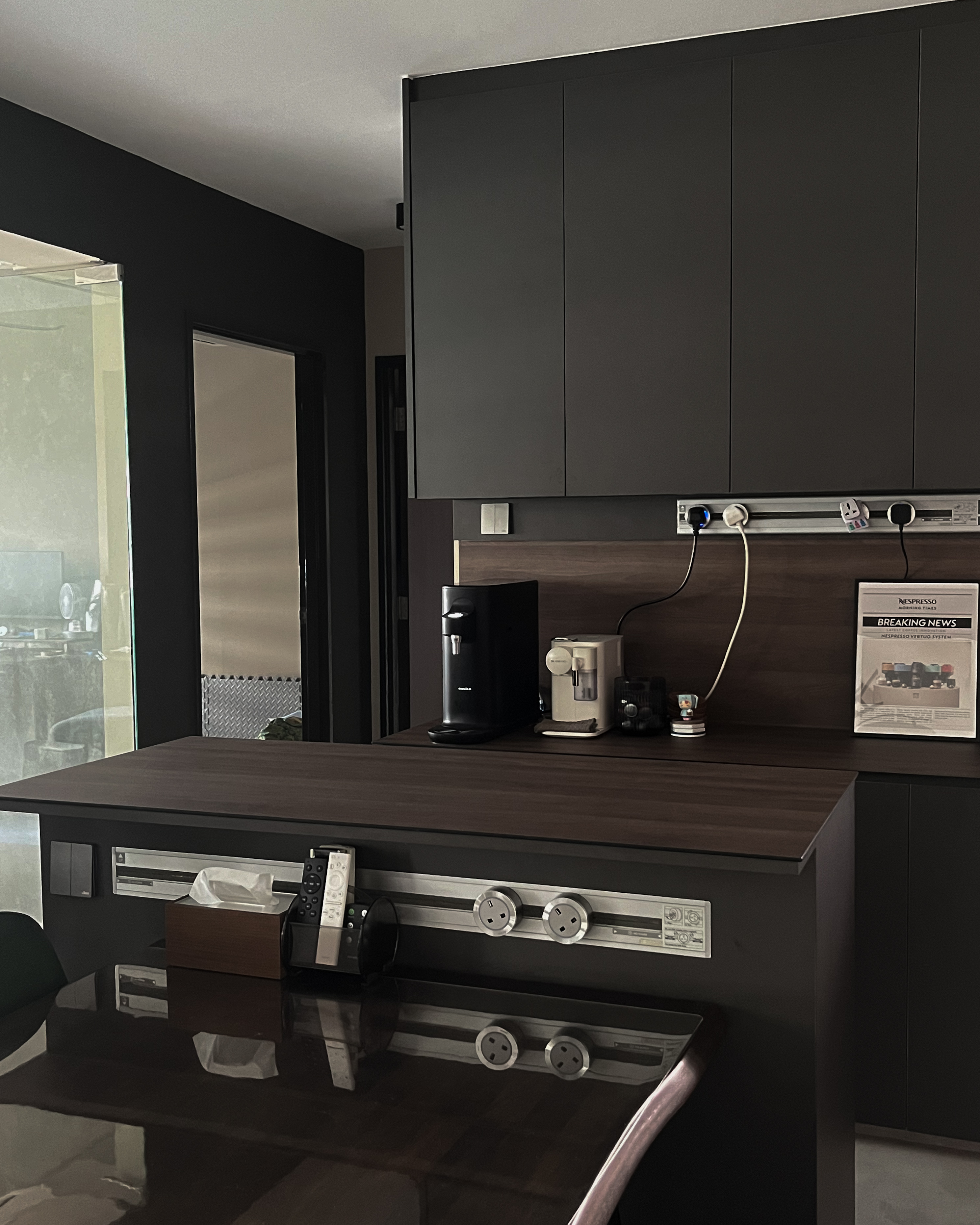 How Our Dark, Contemporary Kitchen Transforms From Day to Night - Dark kitchen cabinetry, sleek appliances, coffee maker