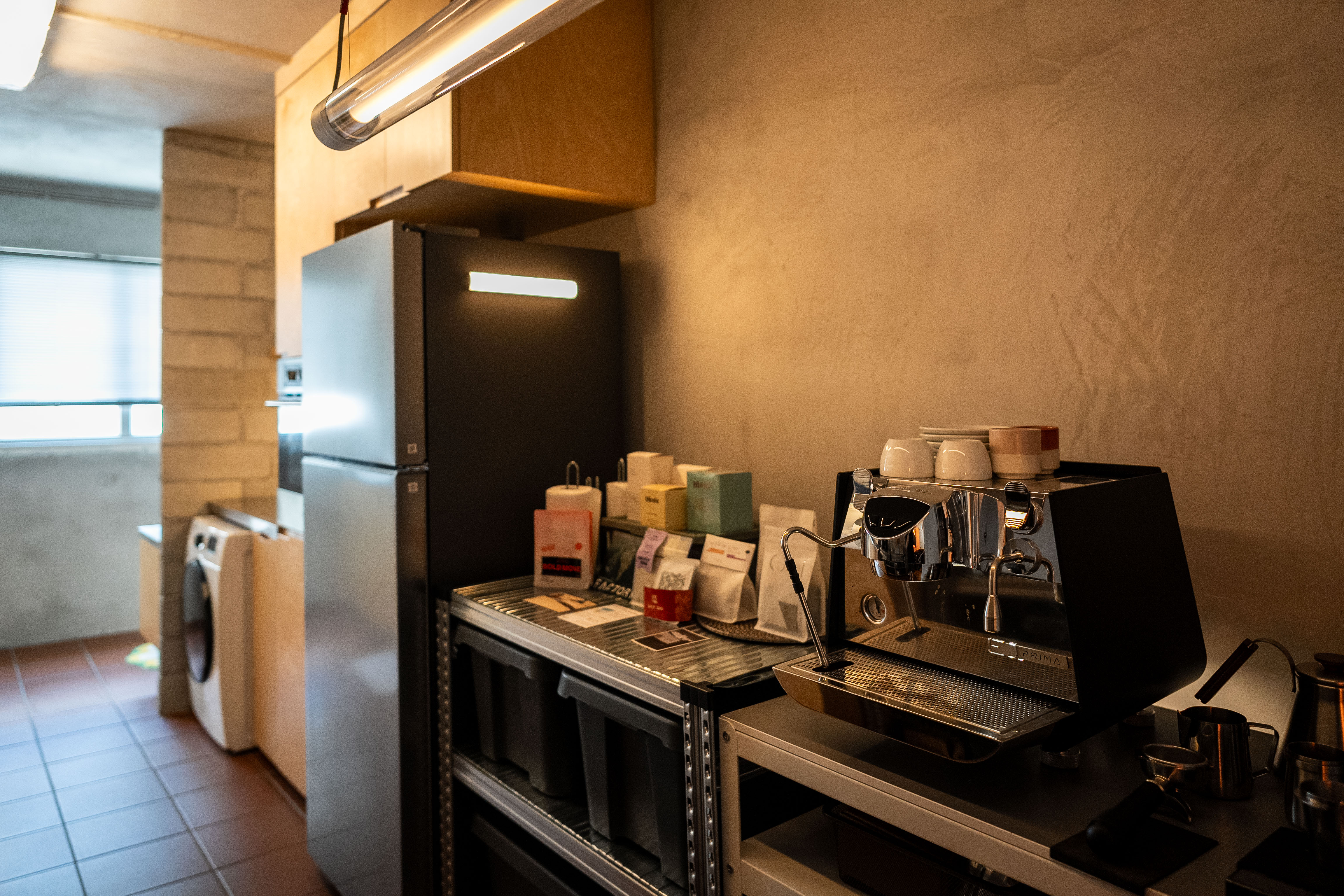 A Coffee Lover's Spacious & Charming Kitchen - Modern kitchen with stainless steel appliances, concrete wall, wooden