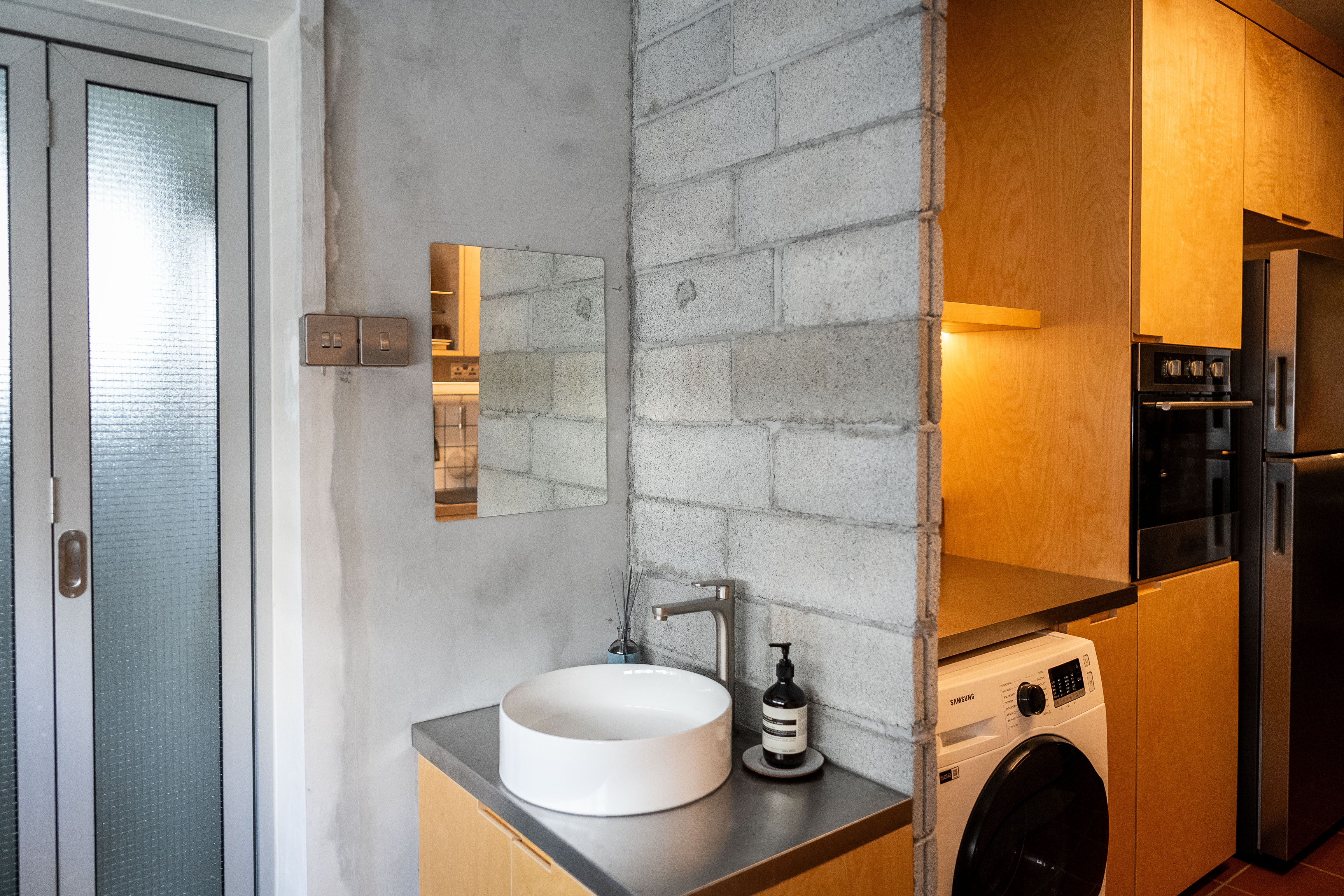 A Coffee Lover's Spacious & Charming Kitchen - Modern kitchen with concrete wall, wooden cabinets, stainless steel