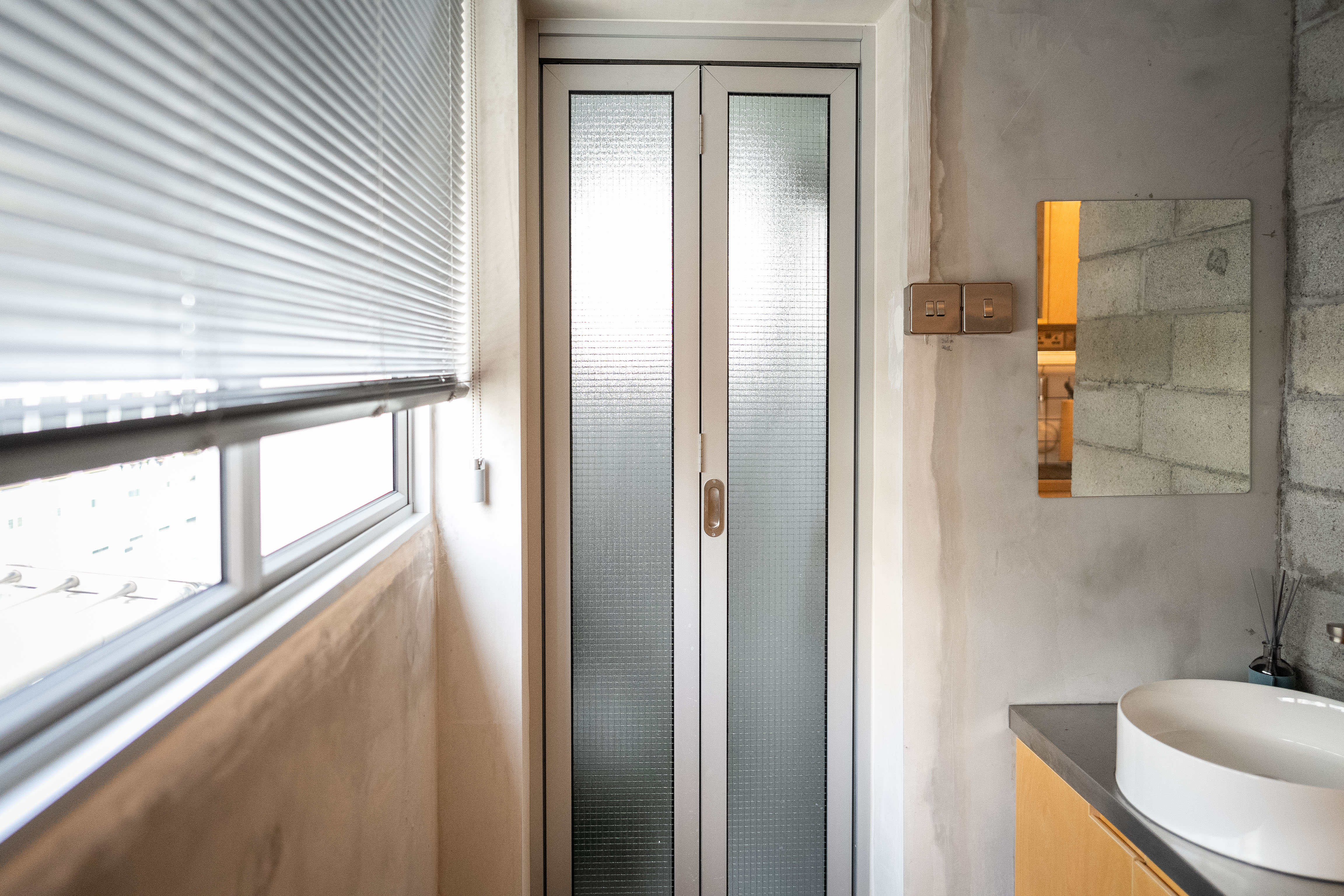 A Coffee Lover's Spacious & Charming Kitchen - Modern bathroom interior, minimalist design, large window with blinds, natural