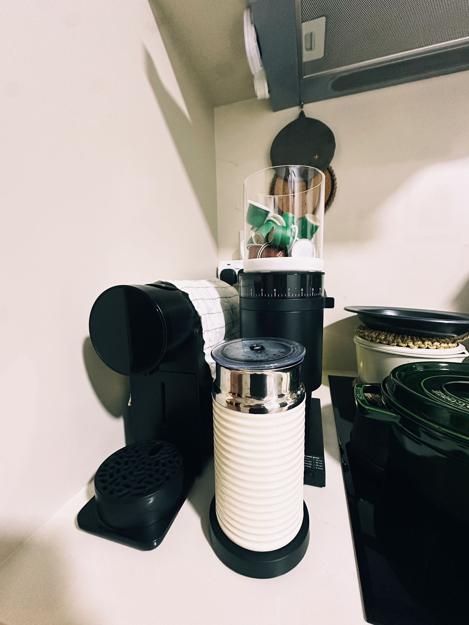 Maximizing Function in a Minimalist Kitchen: Our Small Cooking Haven  - black coffee maker, white and black blender, green