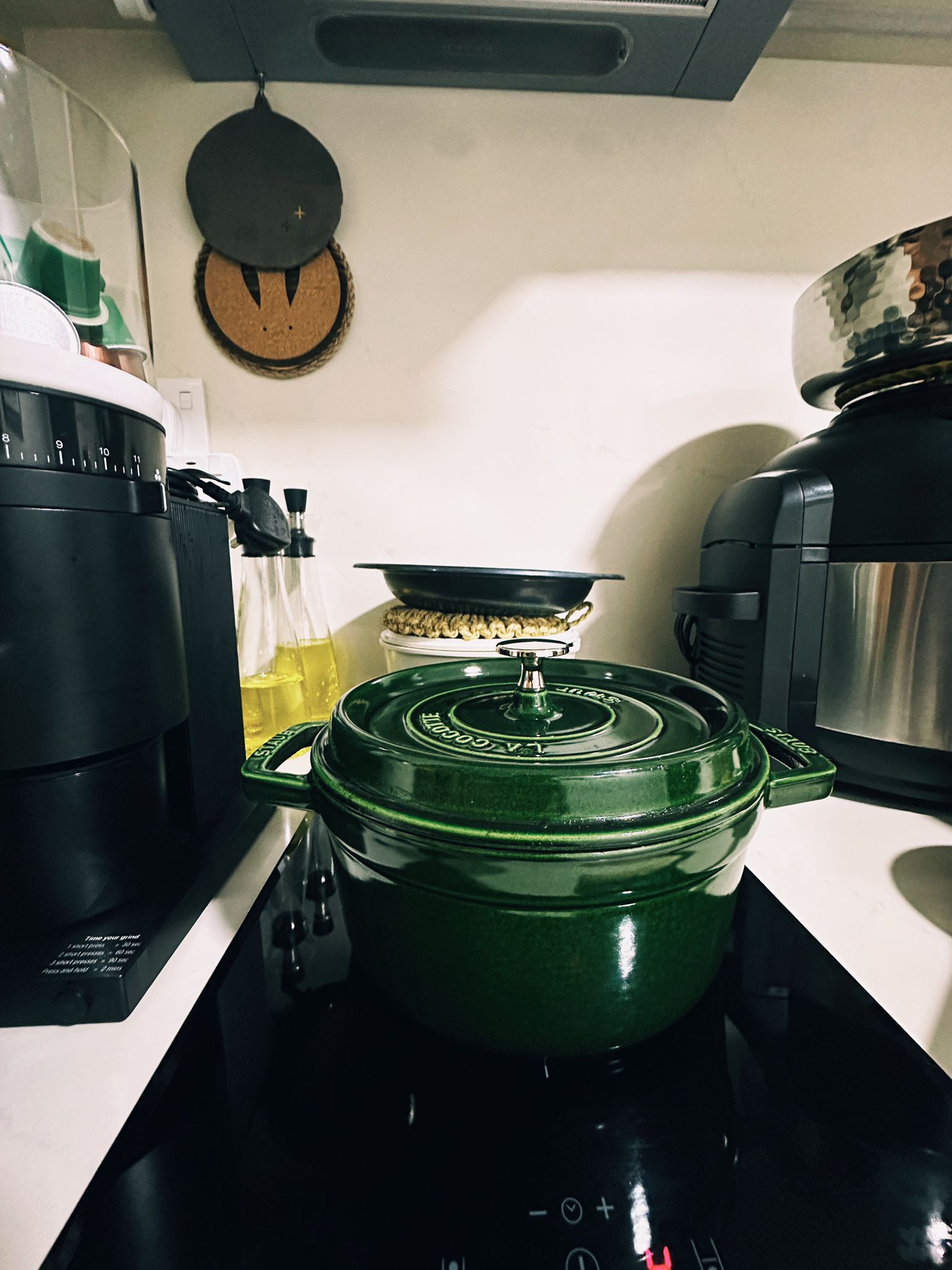 Maximizing Function in a Minimalist Kitchen: Our Small Cooking Haven  - Green cast iron pot on stove, black kitchen