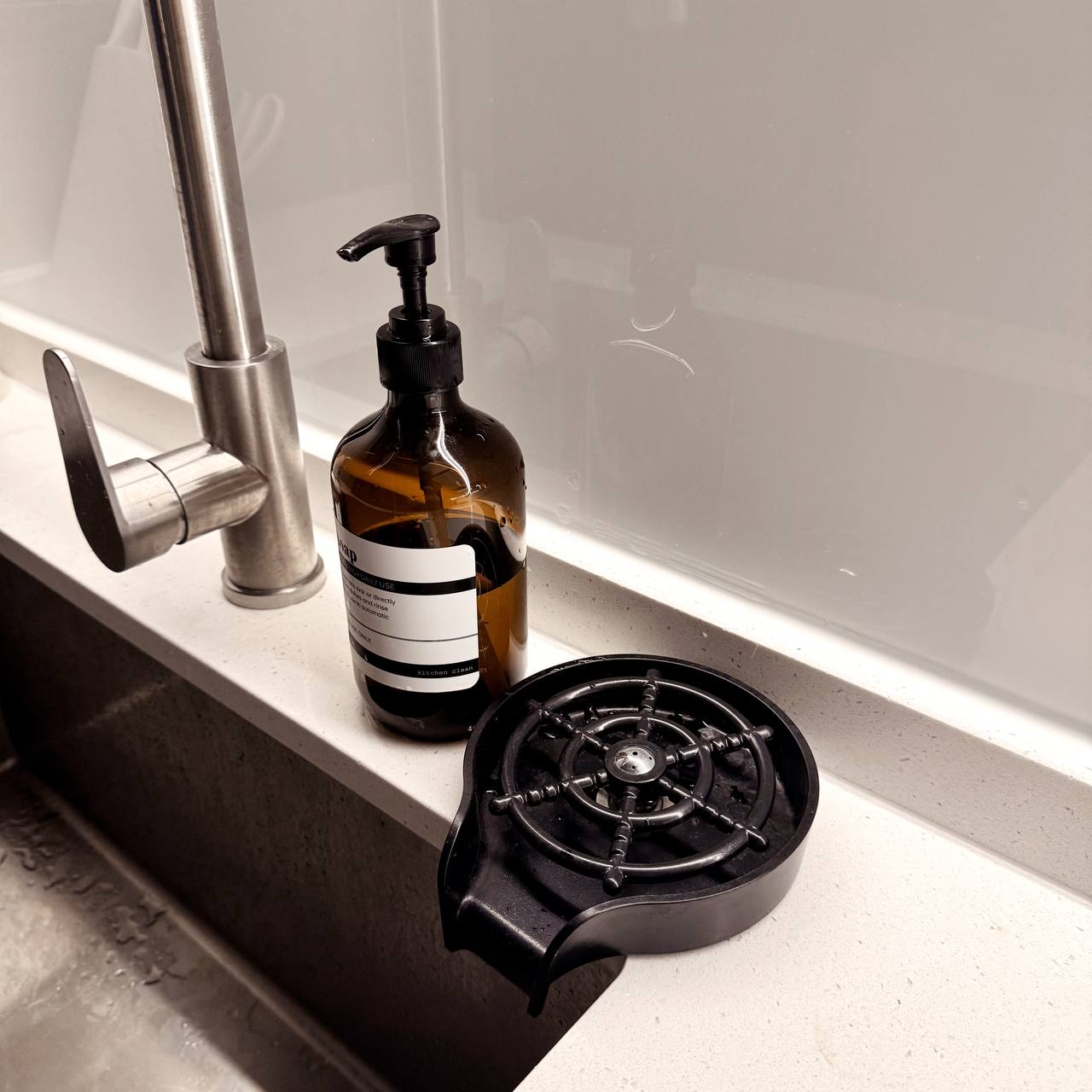 Inside Our Open Concept Kitchen: Practical & Functional - silver faucet, brown soap dispenser, black kitchen stove, white