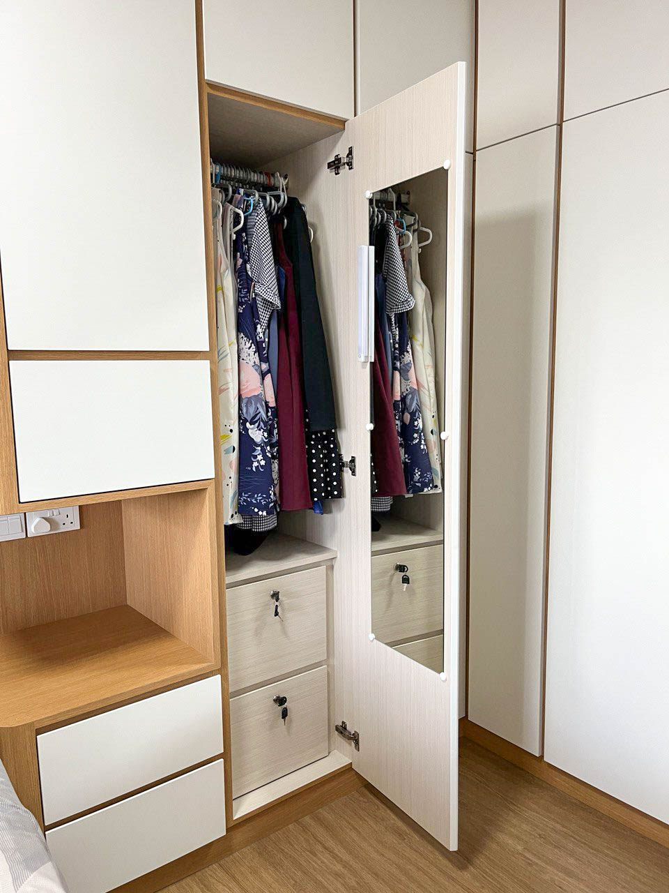From Vision to Reality: Revamping Our Master Vanity Space - Wooden wardrobe with mirrored doors, open and fully stocked with