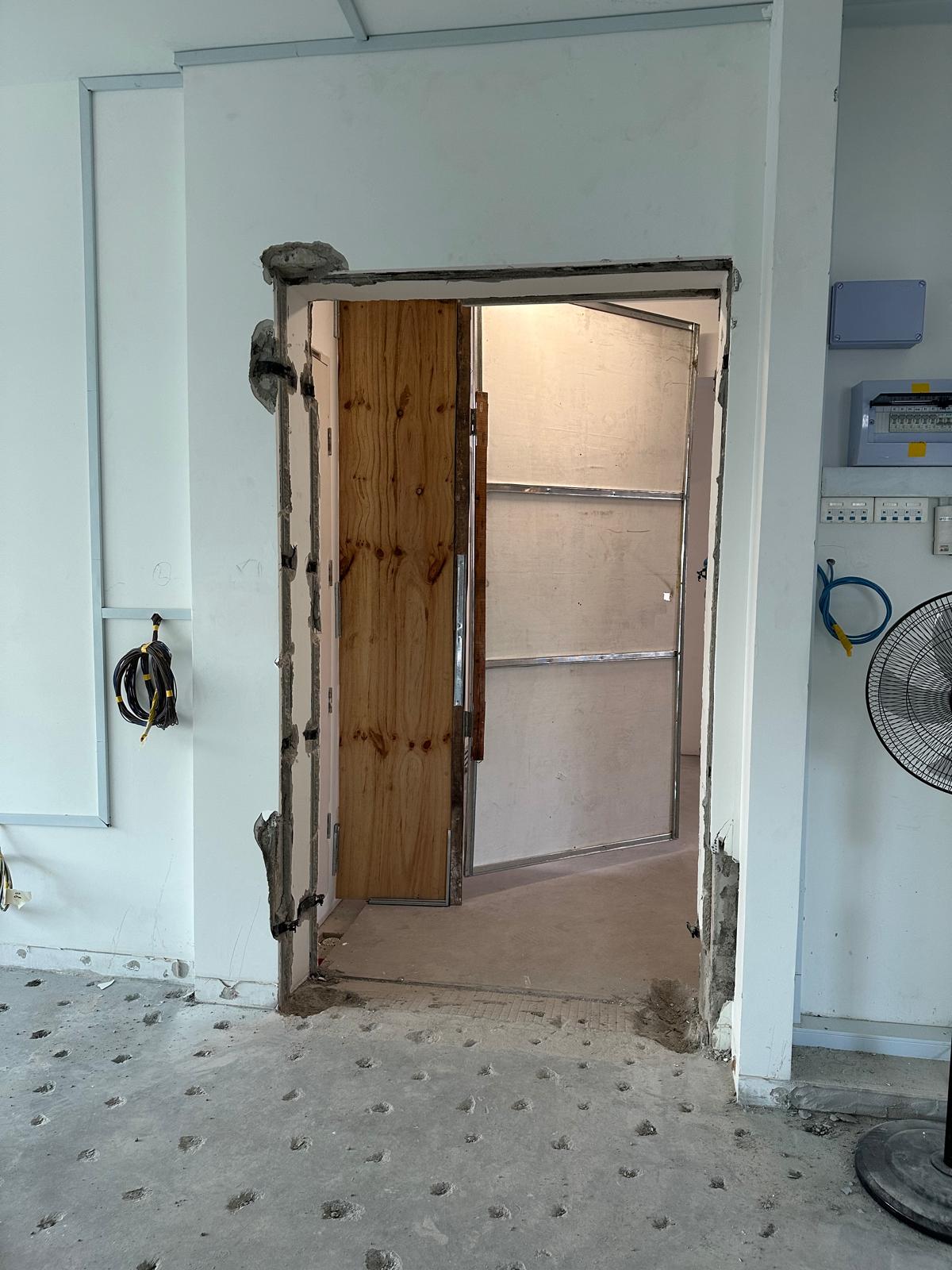 Before & After: Japandi Luxe Entryway - doorway, unfinished walls, exposed wiring, wooden door frame, electrical panel, fan