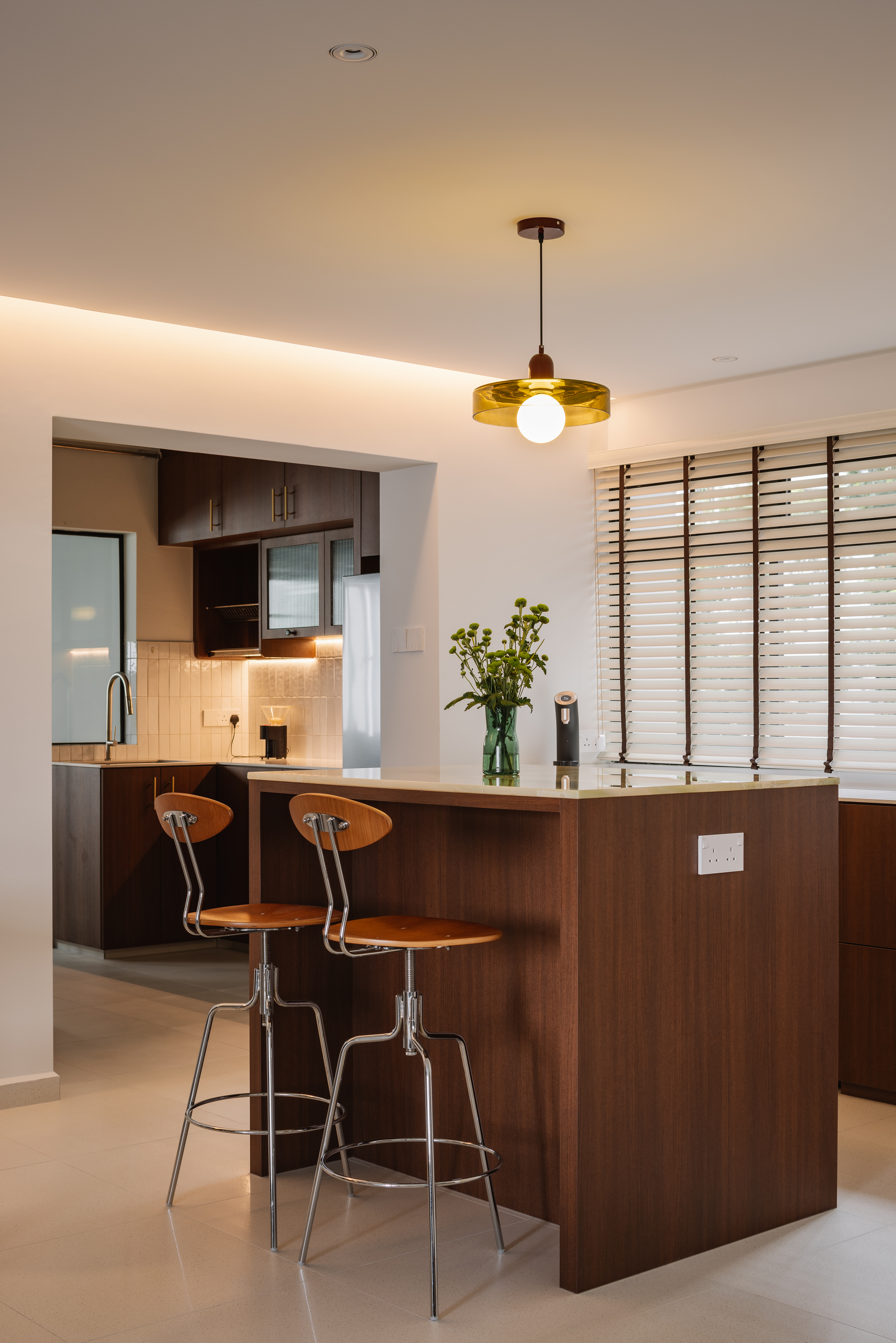 Working Around a Compact Kitchen with an Extended Dry Pantry - Modern kitchen with sleek design, wooden cabinetry, stainless