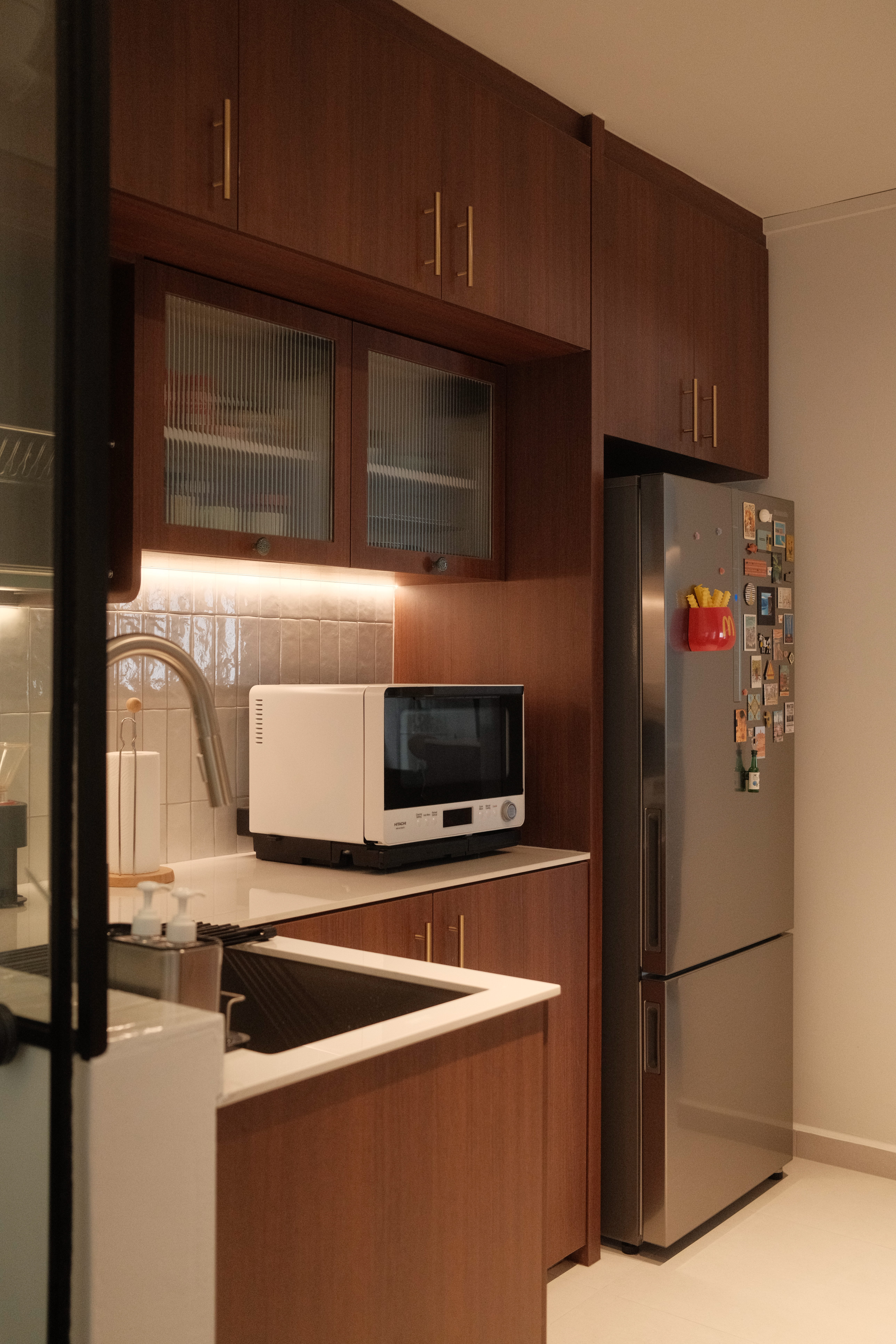 Working Around a Compact Kitchen with an Extended Dry Pantry - Wooden kitchen cabinets, stainless steel refrigerator, white