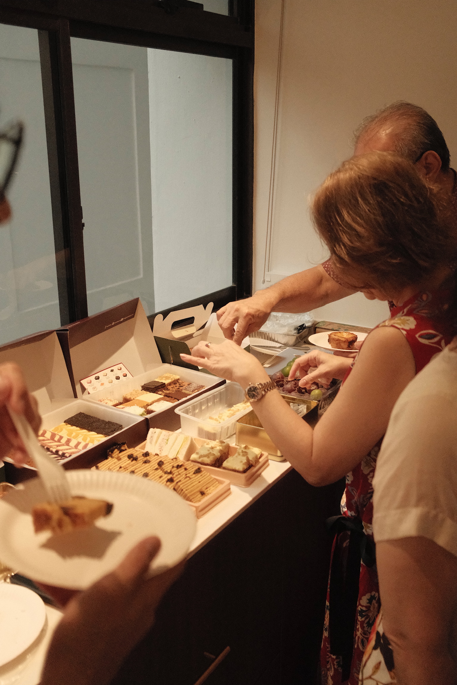 Working Around a Compact Kitchen with an Extended Dry Pantry - party guests, sharing dessert, open boxes, colorful treats