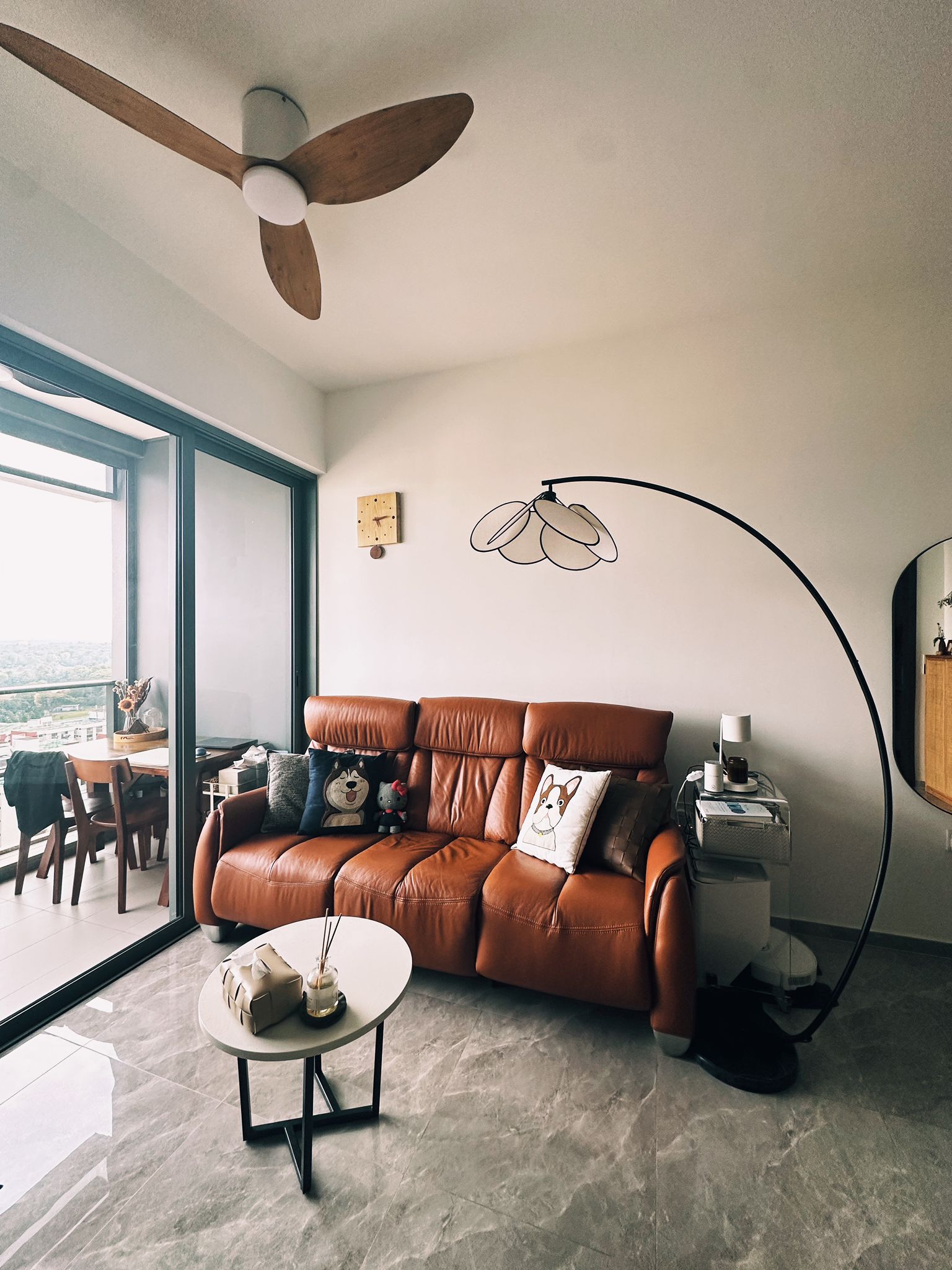 Before / After: Zero Renovation, Maximum Comfort - Modern living room with large brown leather sofa, floor-to-ceiling