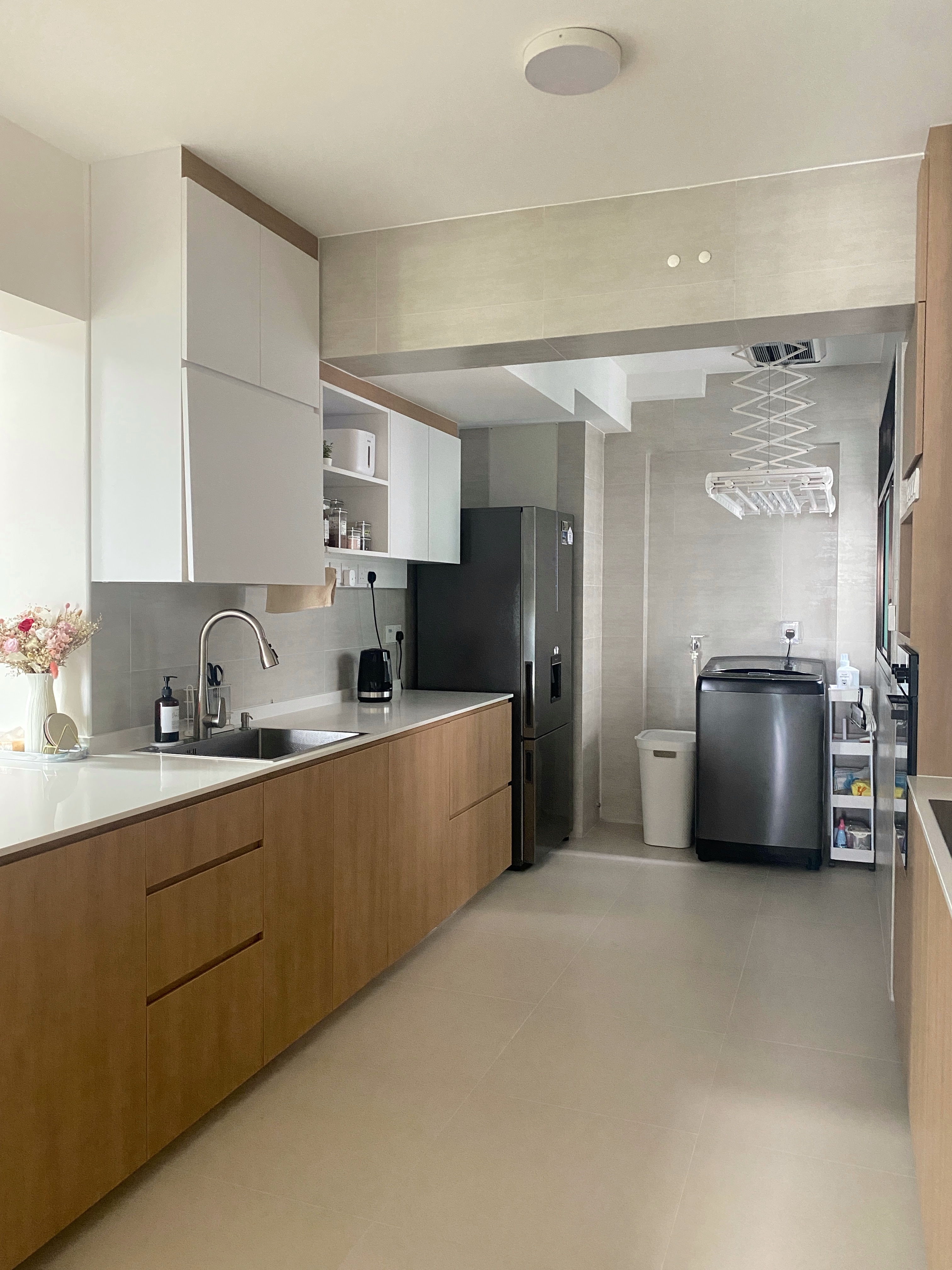 Kitchen: Multifunctional Space Combining Laundry and Cooking Area - Modern kitchen with sleek cabinetry, stainless steel