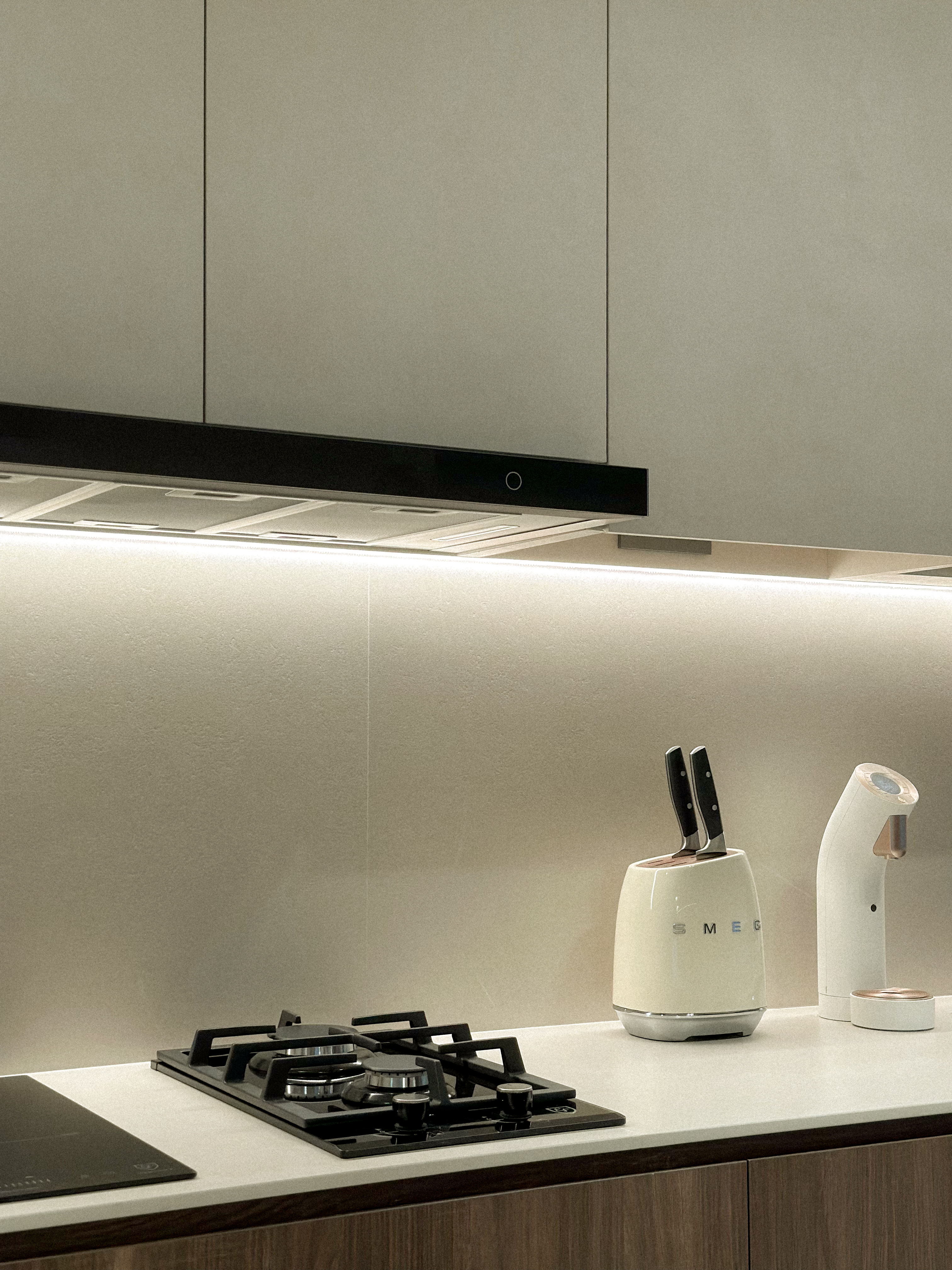 Stir Wars: The Kitchen Awakens 🥘 - modern kitchen countertop, sleek cabinets, black range hood, white electric kettle, knife