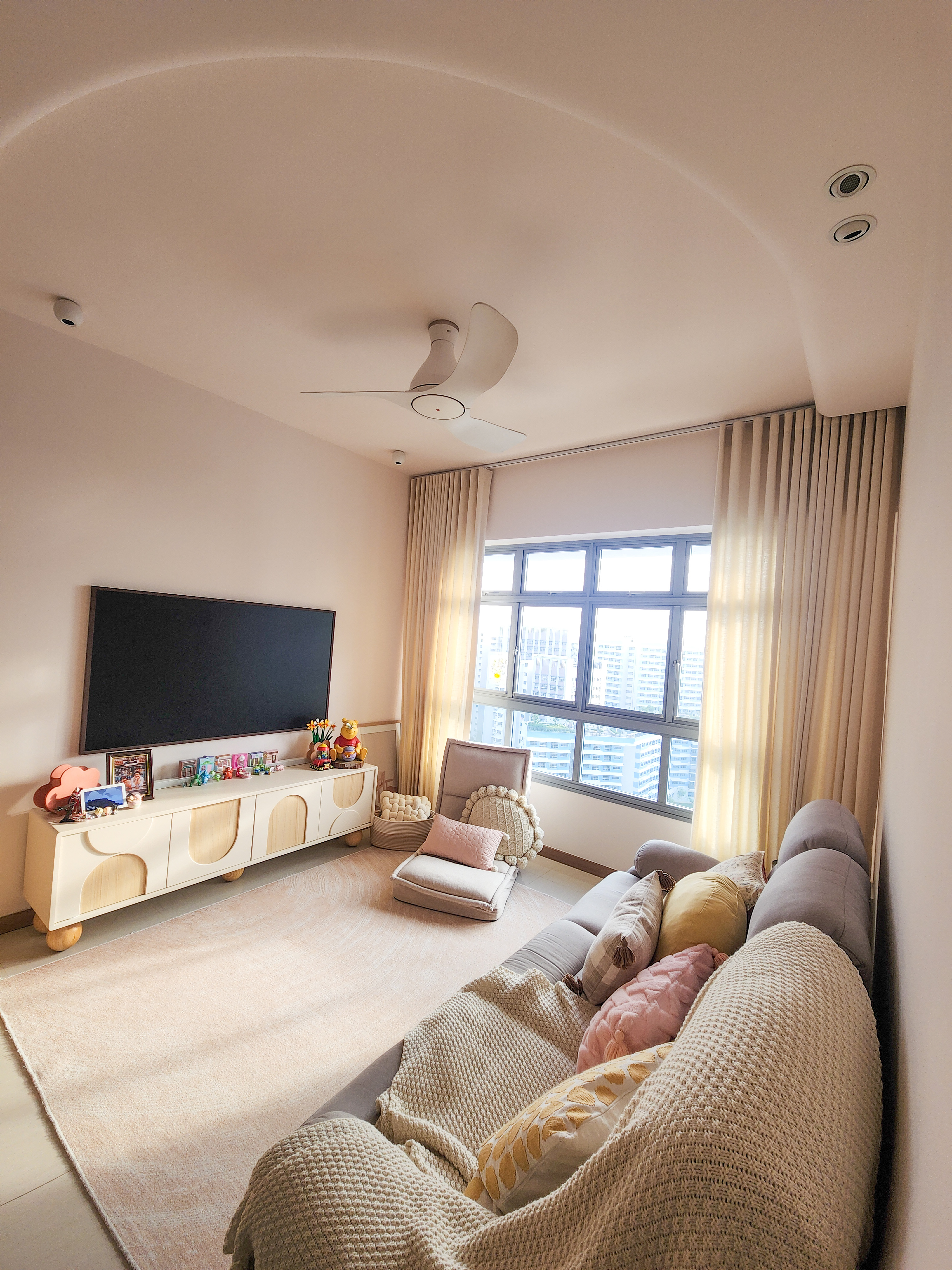 Our Cosy Living Room: ZERO CARPENTRY & Hints of Disney Magic! - Modern living room with large window, beige curtains