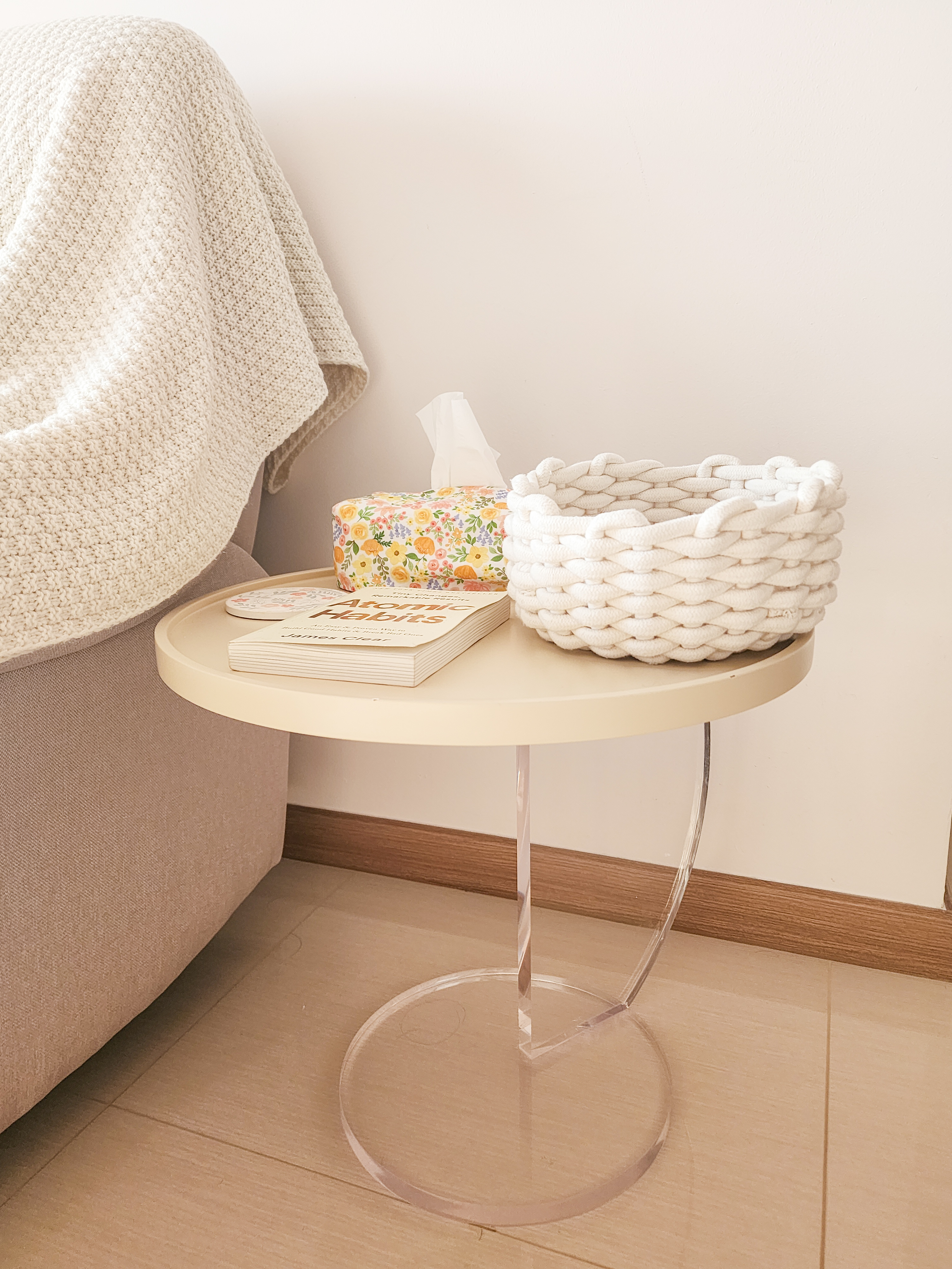 Our Cosy Living Room: ZERO CARPENTRY & Hints of Disney Magic! - Cream knitted blanket, beige wall, round table, white wicker