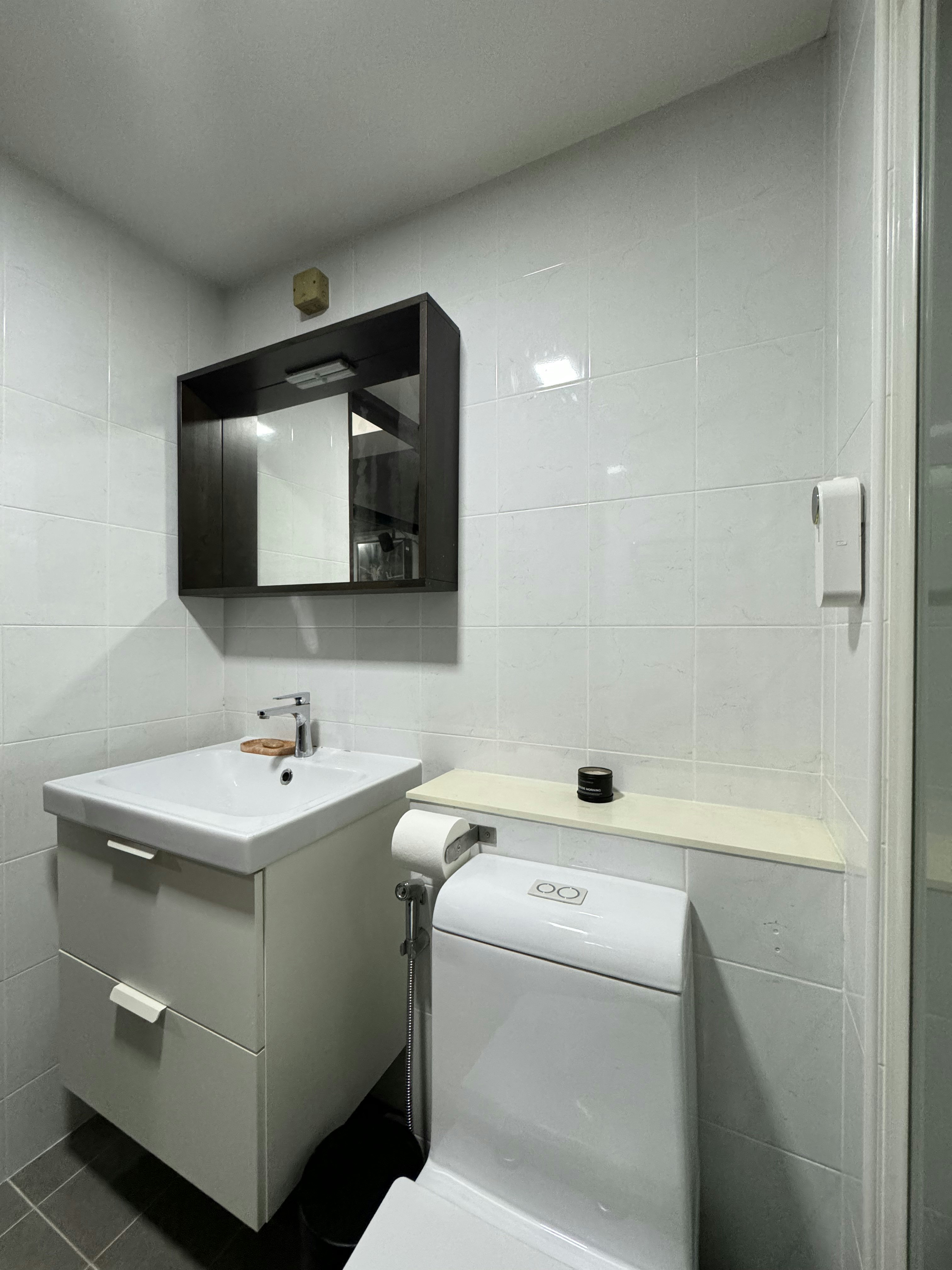 $31K Renovation Budget 5-Room HDB Mid-Century & Eclectic - White tiled bathroom, modern sink, black cabinet, mirror above