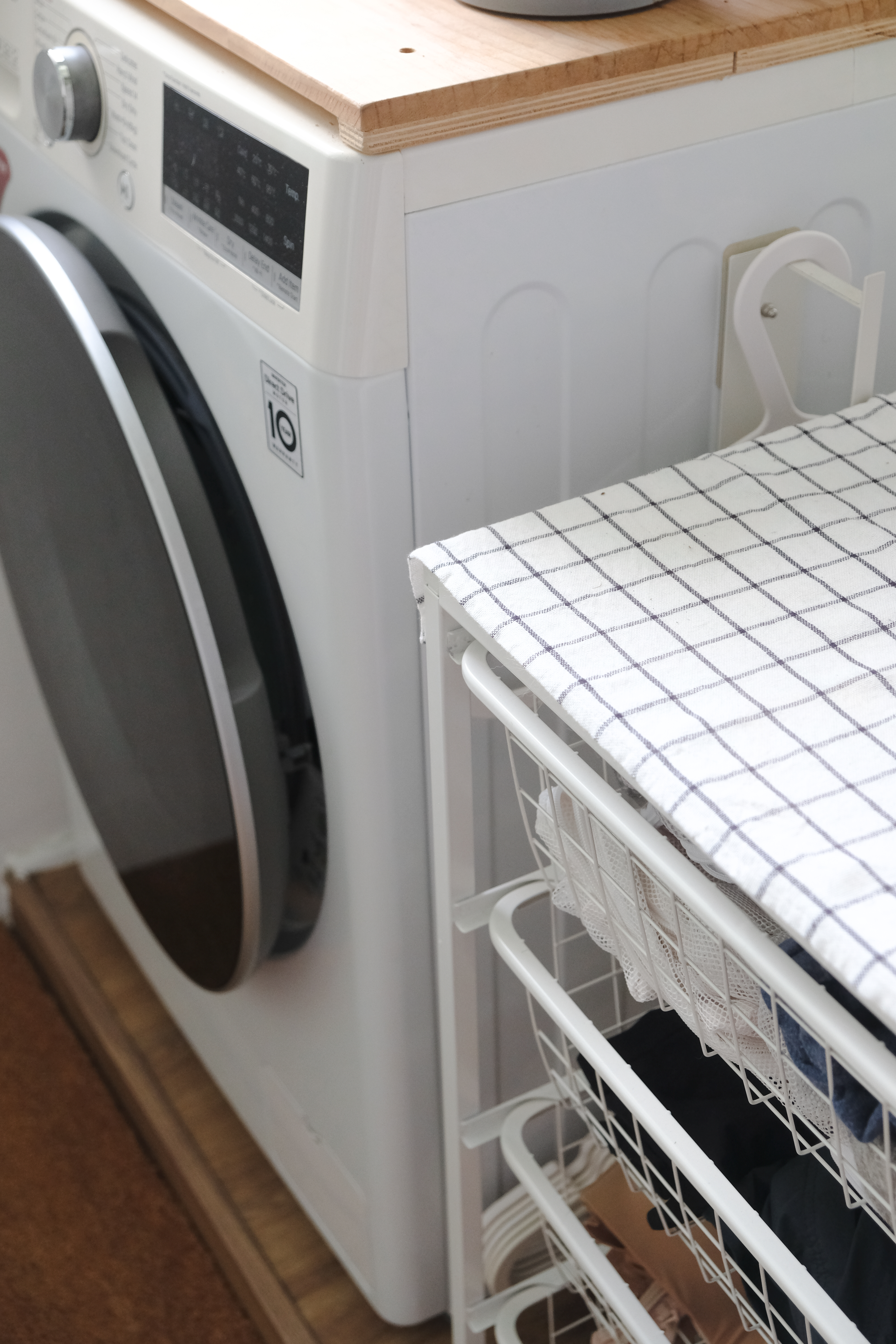 Clean and Functional: A Kitchen Designed with Smart Storage Solutions - Washing machine, dryer, and ironing board, white