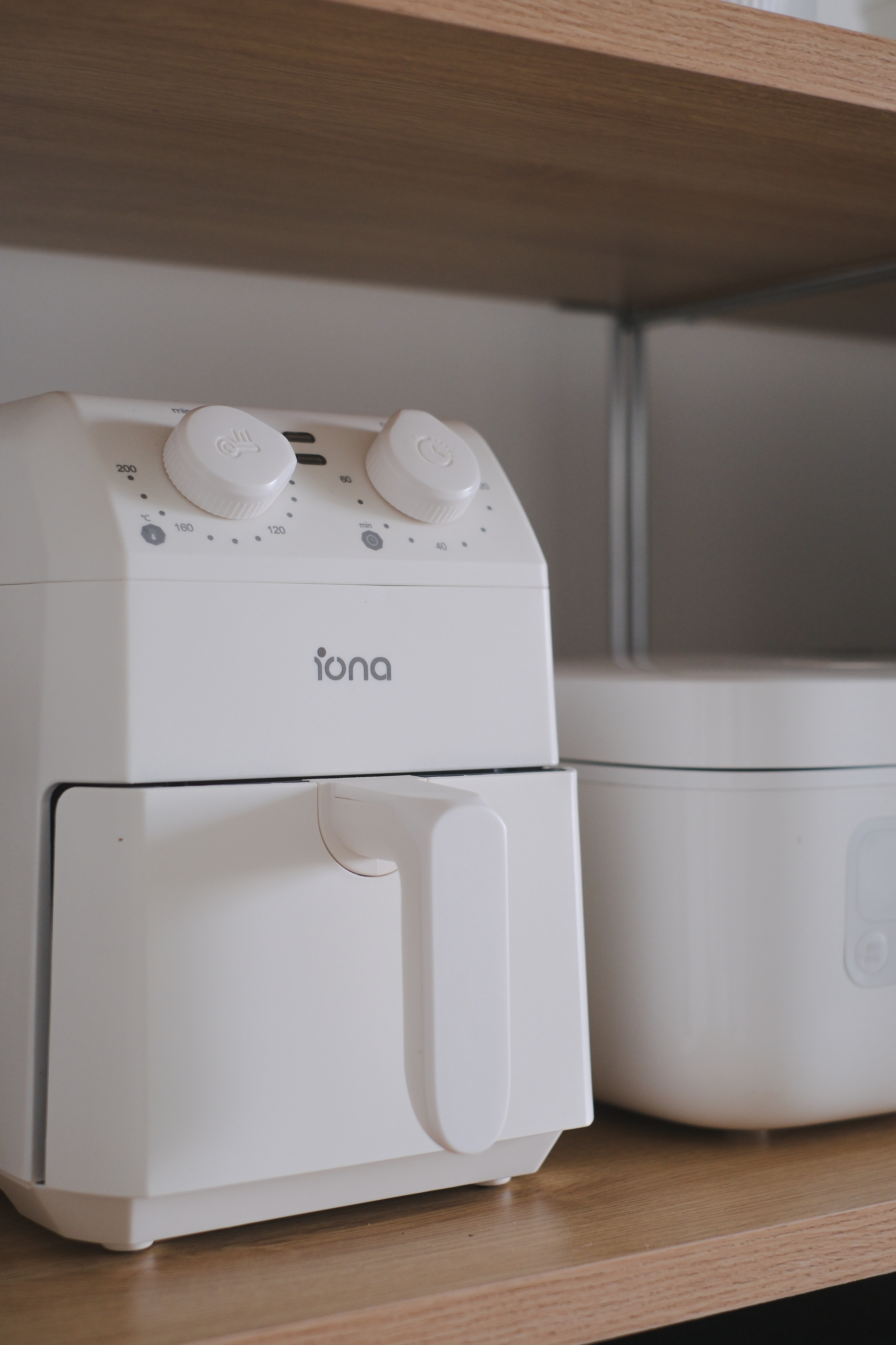 Clean and Functional: A Kitchen Designed with Smart Storage Solutions - White toaster with control knobs, Iona brand, modern
