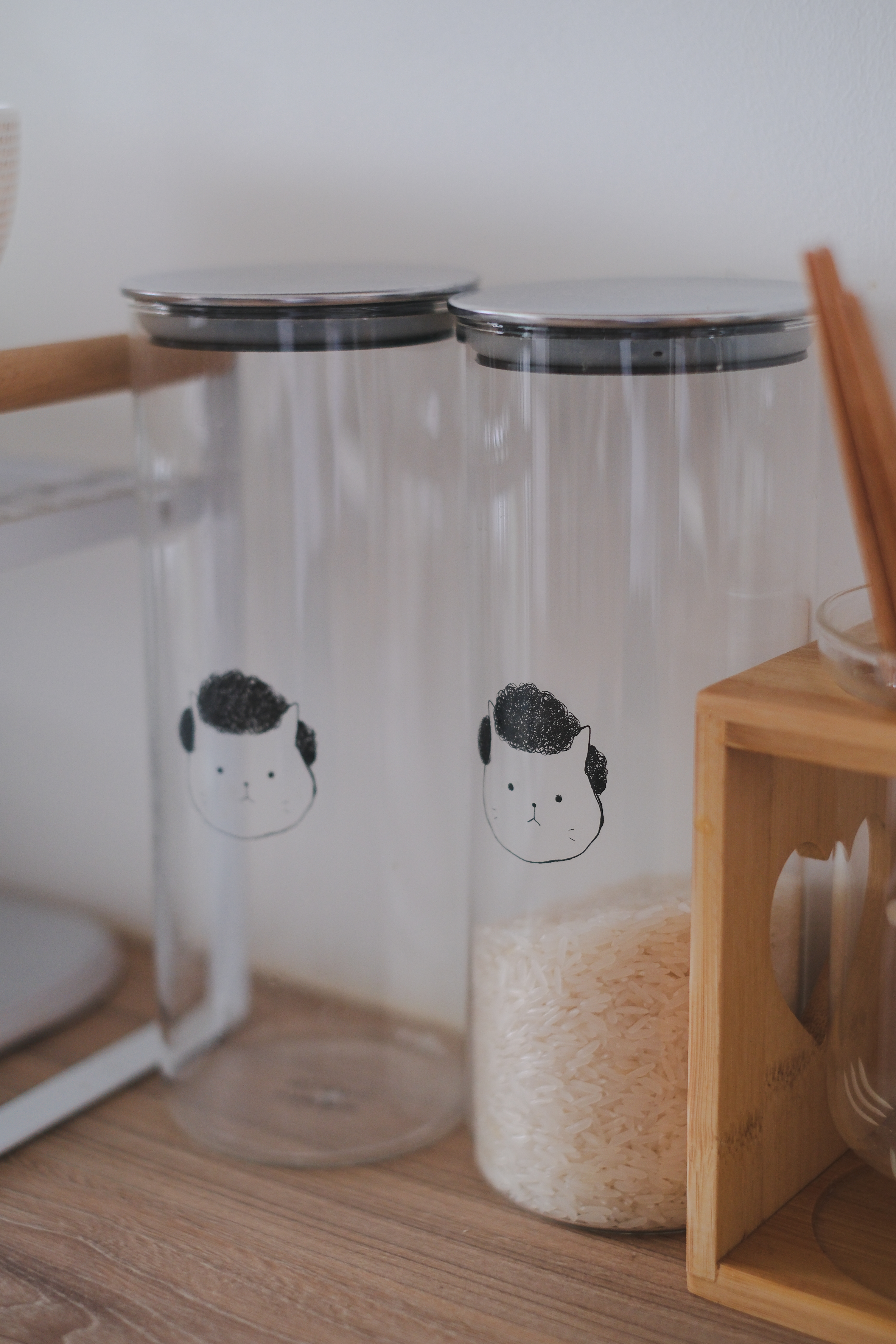 Clean and Functional: A Kitchen Designed with Smart Storage Solutions - clear glass jars, black cat face design, white rice