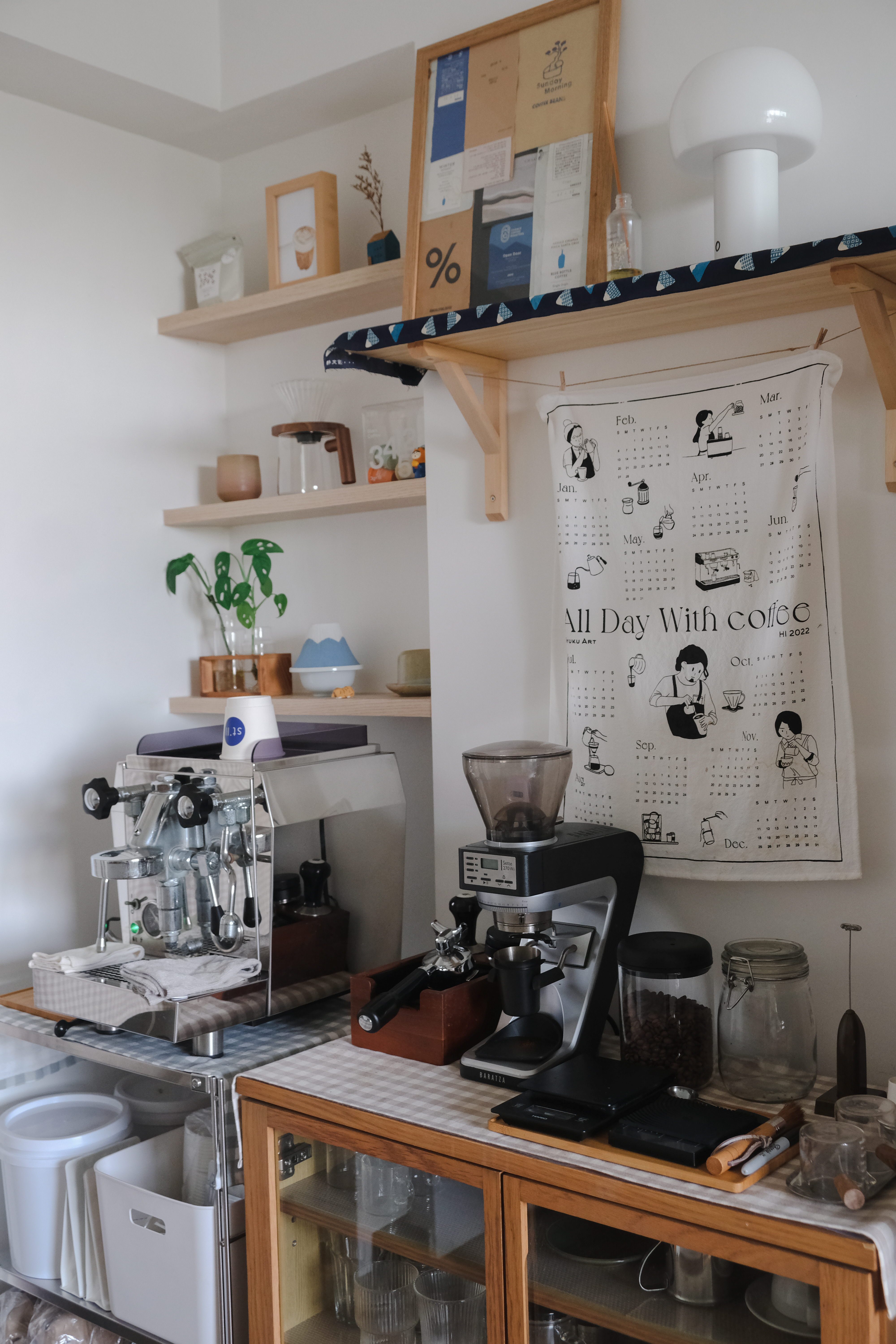 Clean and Functional: A Kitchen Designed with Smart Storage Solutions - Shelf with various items, coffee machine, calendar
