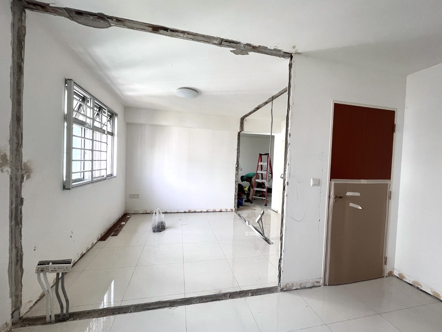 Here are some great ideas for renovating a small bedroom - White-tiled room, unfinished walls, exposed beams, large window