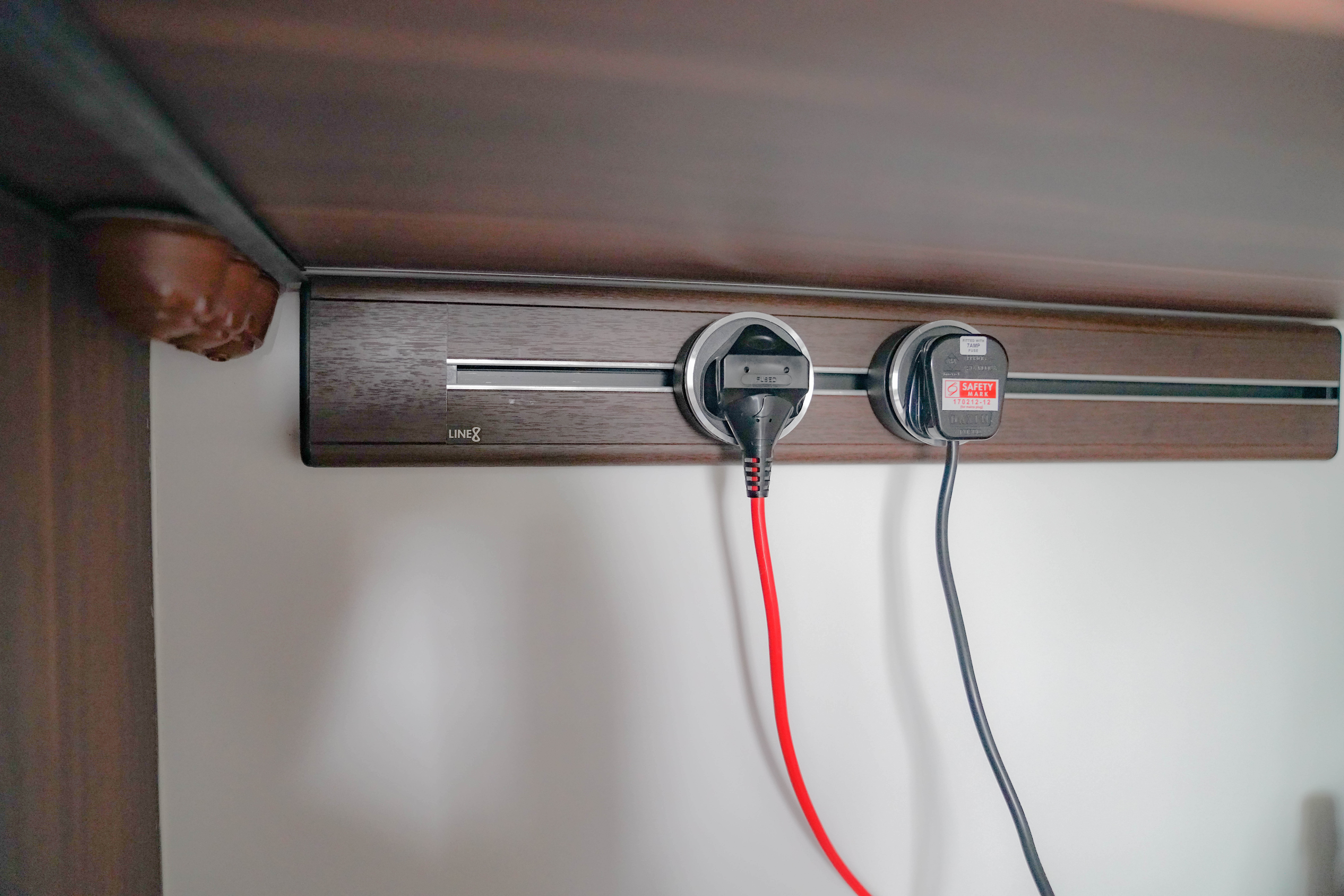 A Kitchen of Thoughtful Details - Wooden nightstand, charging station, USB cable, power adapter, safety switch, wall outlet