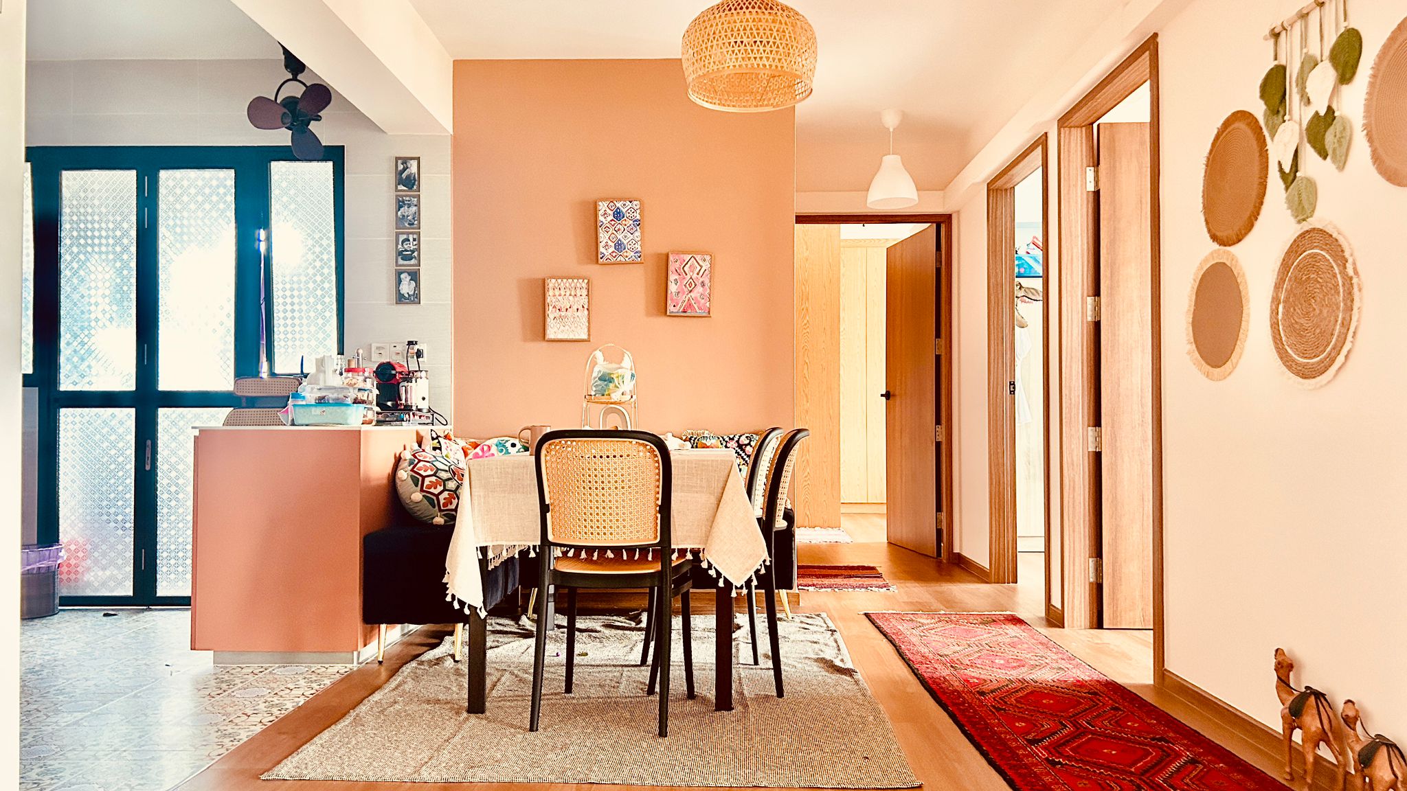 Airy and Inviting: A $26K Bohemian Mediterranean 4-RM BTO - Modern dining room with peach-colored walls, wooden dining table