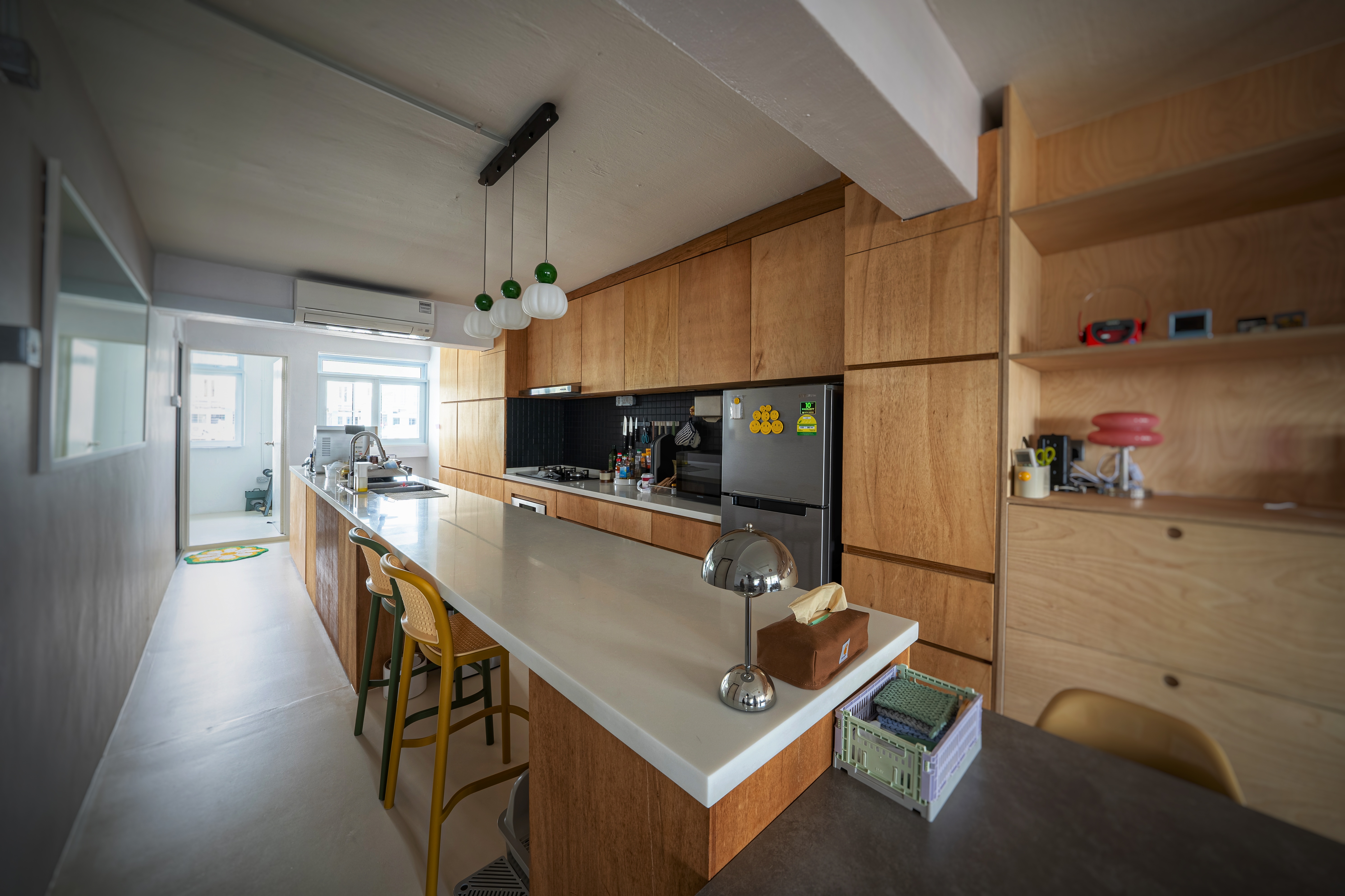 Our open kitchen concept - The plywood pantry. - Wooden kitchen cabinetry, modern appliances, island with bar stools, green