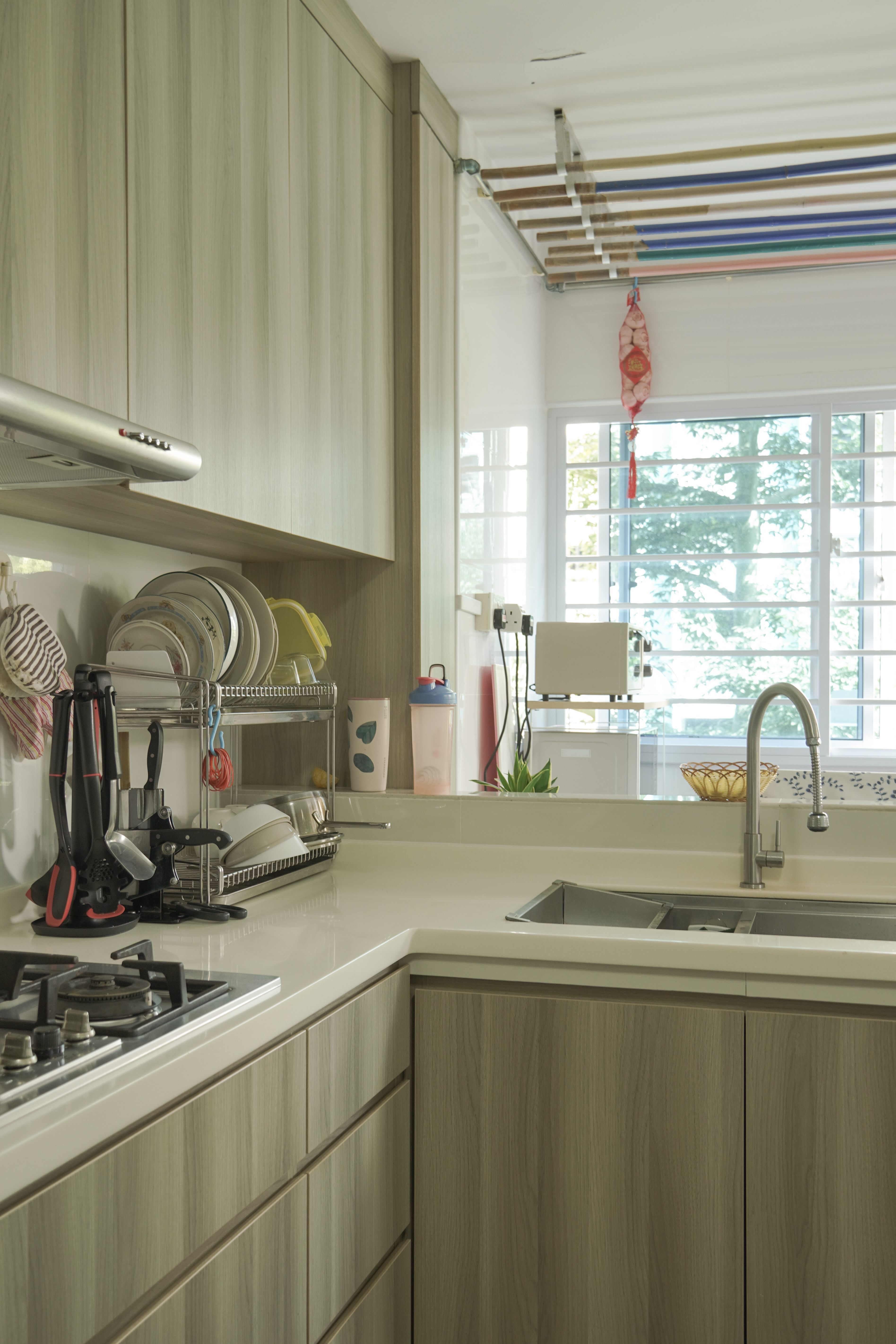 Living in Shared Spaces | Long Kitchen Design of a 5RM Resale - Light wood cabinets, modern kitchen, stainless steel range