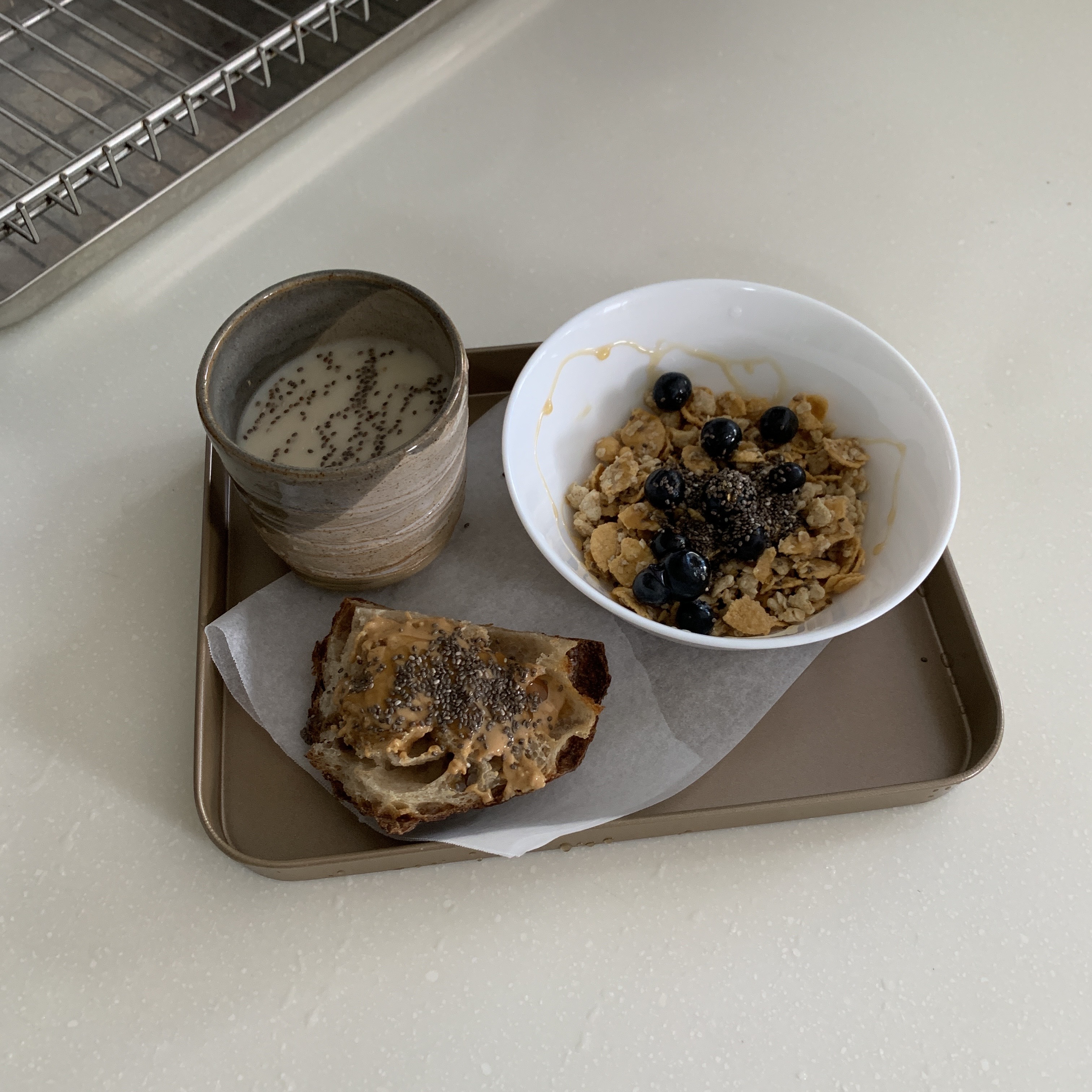 Living in Shared Spaces | Long Kitchen Design of a 5RM Resale - mug of milk, cereal with blueberries, toast with seeds, tray