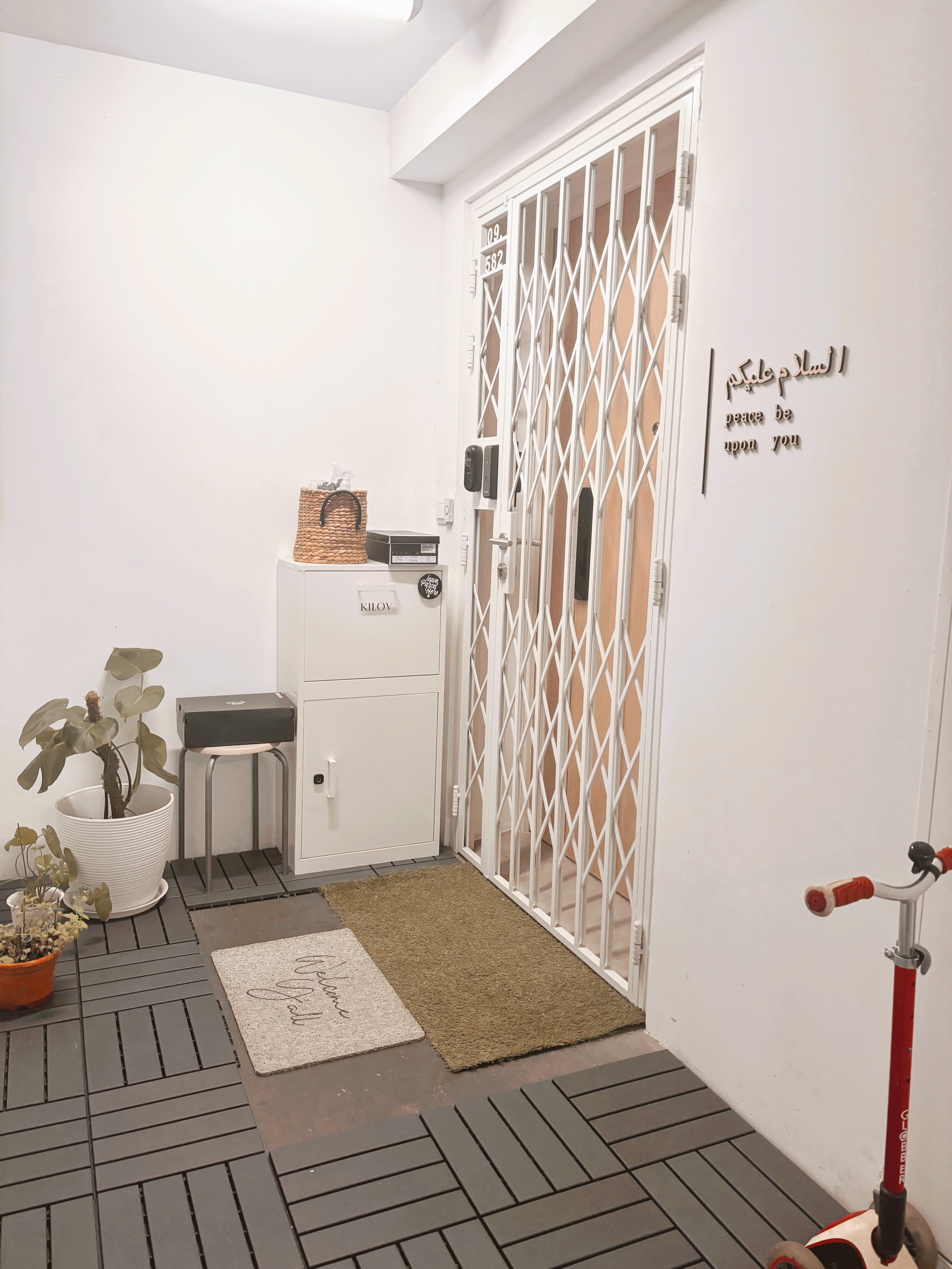 Entrance Glow-Up: Revamping Our Welcoming Space, One Detail at a Time! - White door with metal bars, beige wall, woven basket