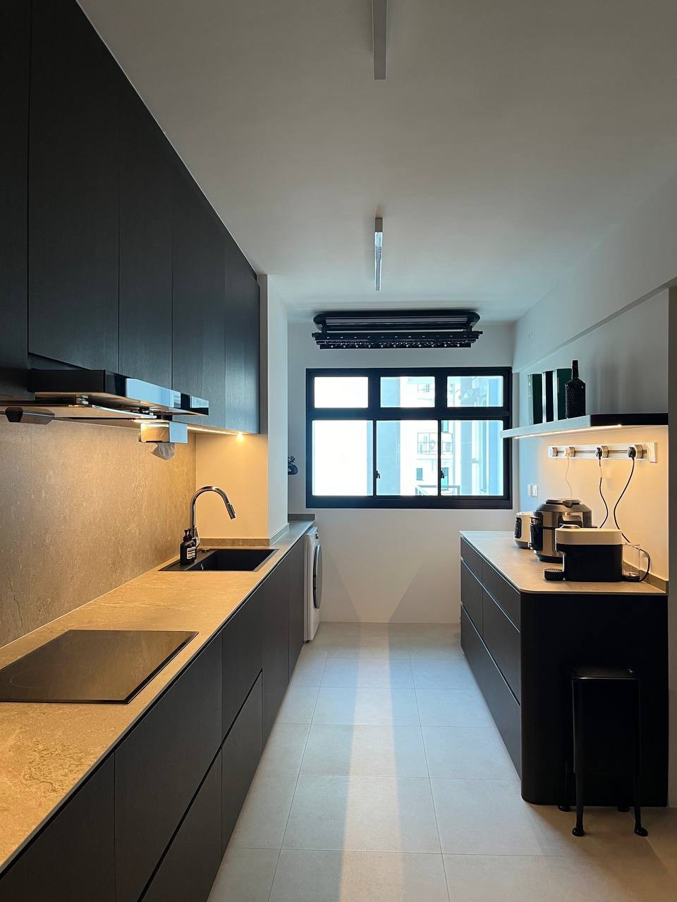 Modern Minimalist 5 Room BTO - Modern kitchen with sleek black cabinetry, beige countertops, under-cabinet lighting