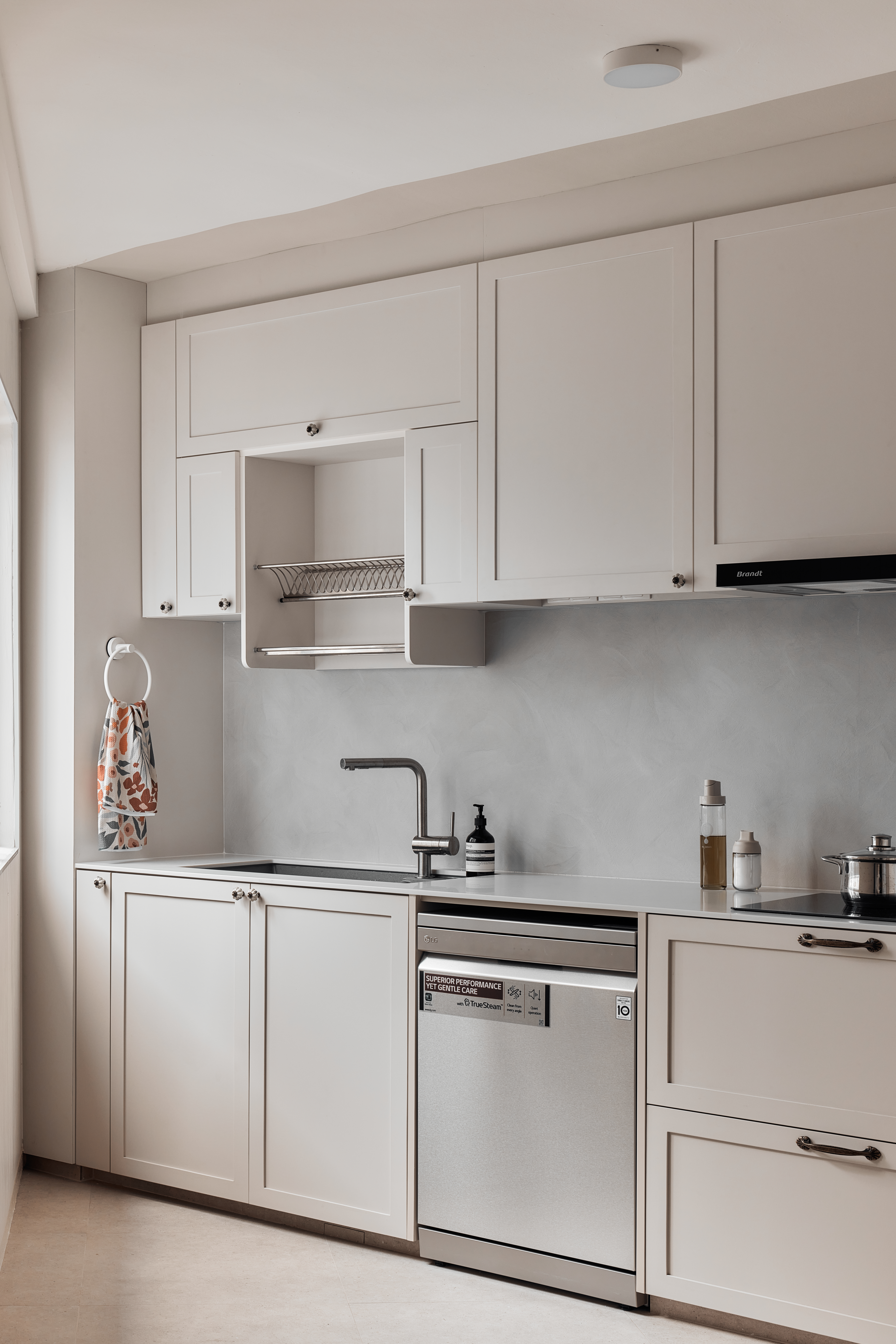 130K 5-room HDB Resale Home Tour: Warm hues, Panels, Barn door - Modern kitchen with sleek white cabinetry, stainless steel