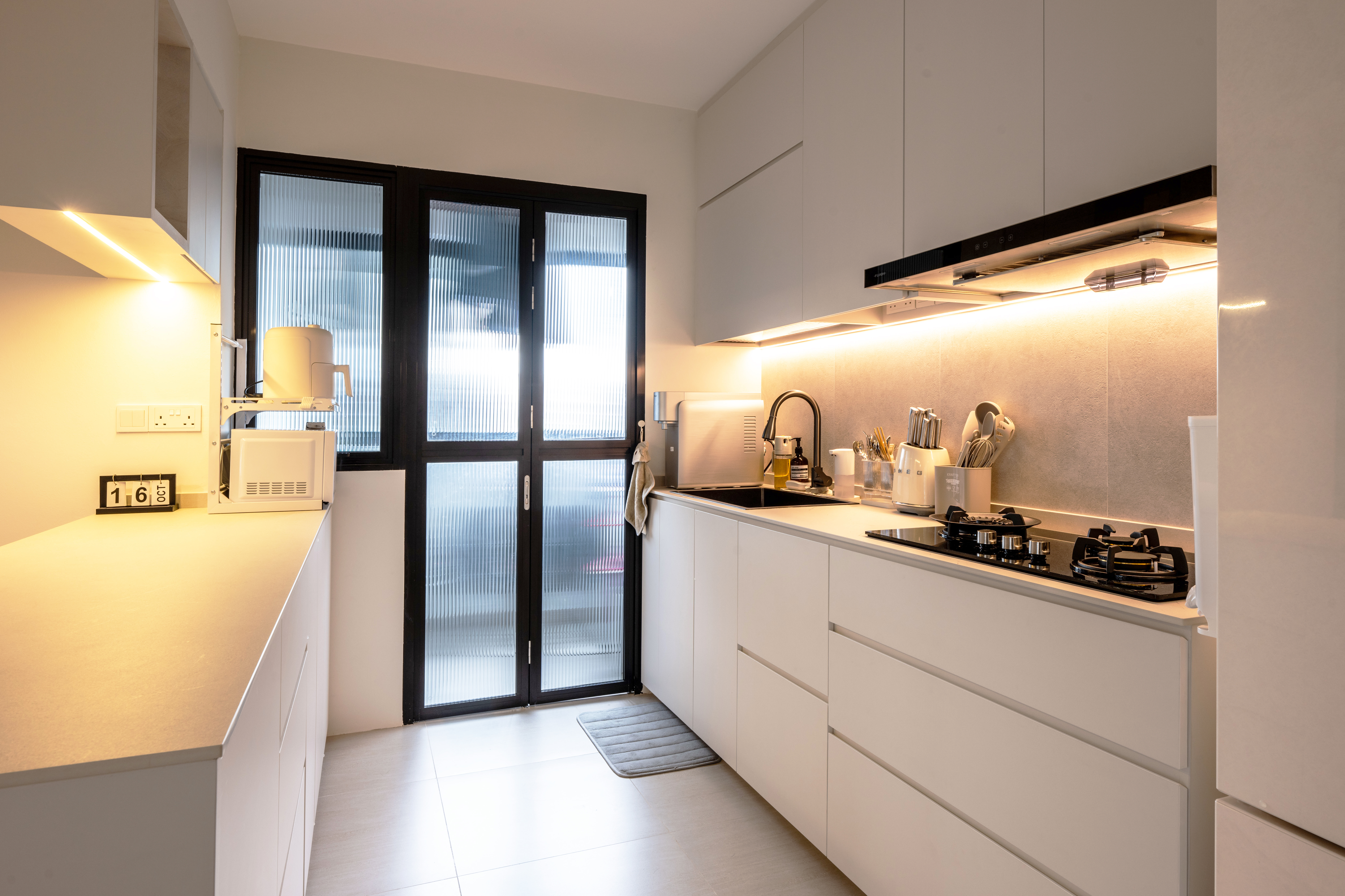 Minimalistic and cozy home for under 34k | 4-room BTO in Tengah - Modern kitchen with sleek white cabinets, illuminated