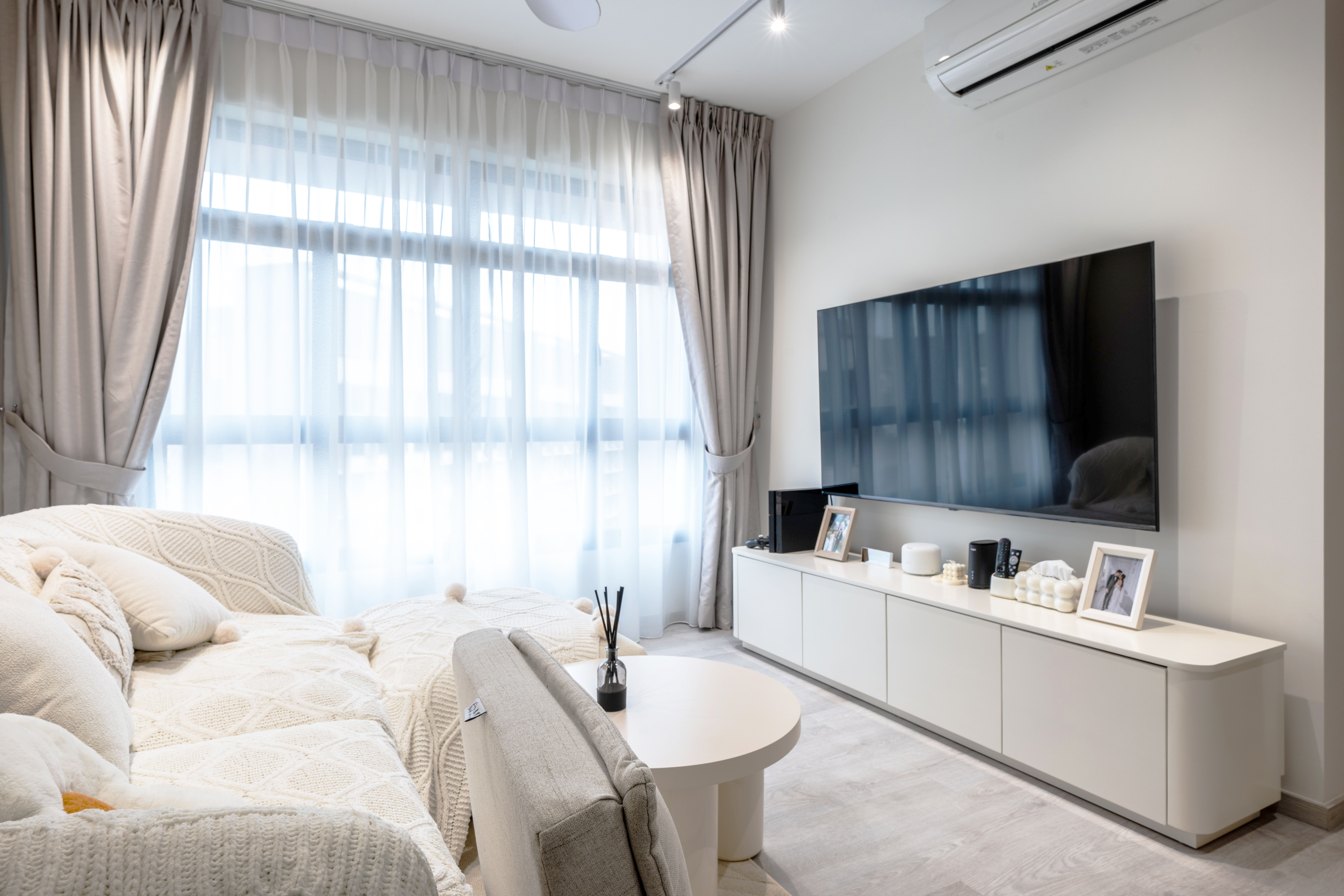 Minimalistic and cozy home for under 34k | 4-room BTO in Tengah - Modern living room with large window, beige curtains, white