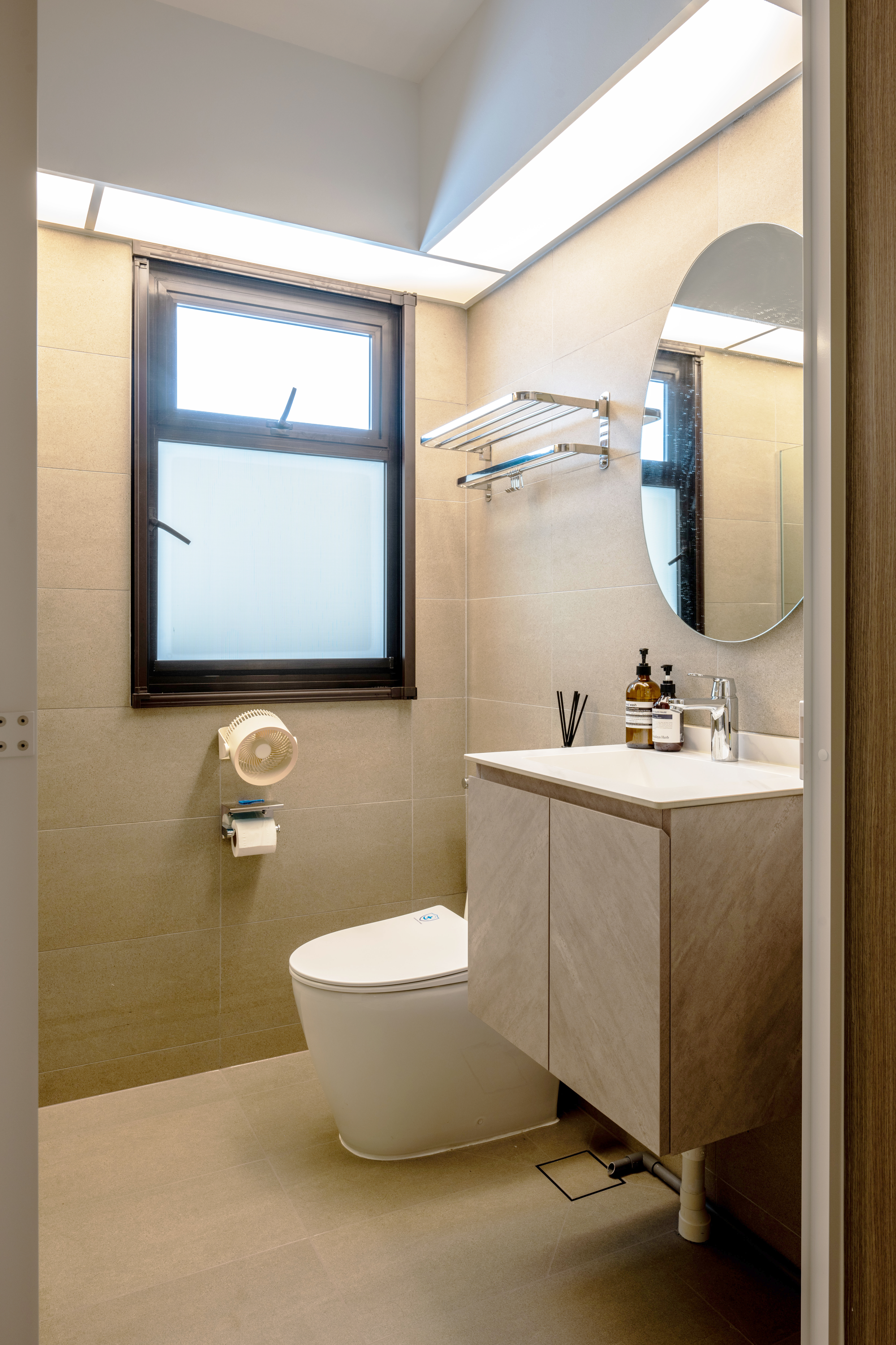 Minimalistic and cozy home for under 34k | 4-room BTO in Tengah - Modern bathroom with beige tiles, sleek white toilet, round