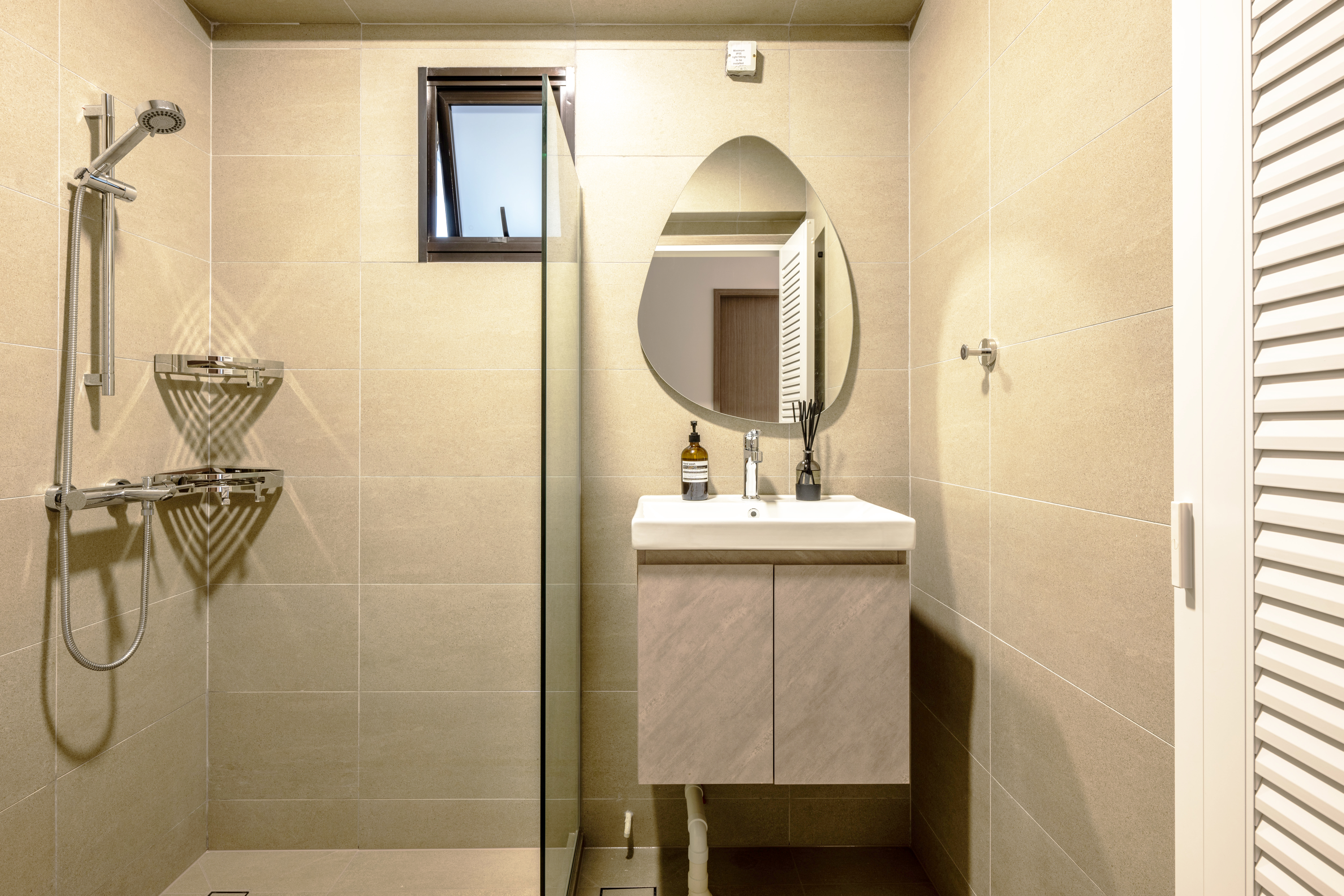 Minimalistic and cozy home for under 34k | 4-room BTO in Tengah - Modern bathroom with beige tiles, sleek shower with rain