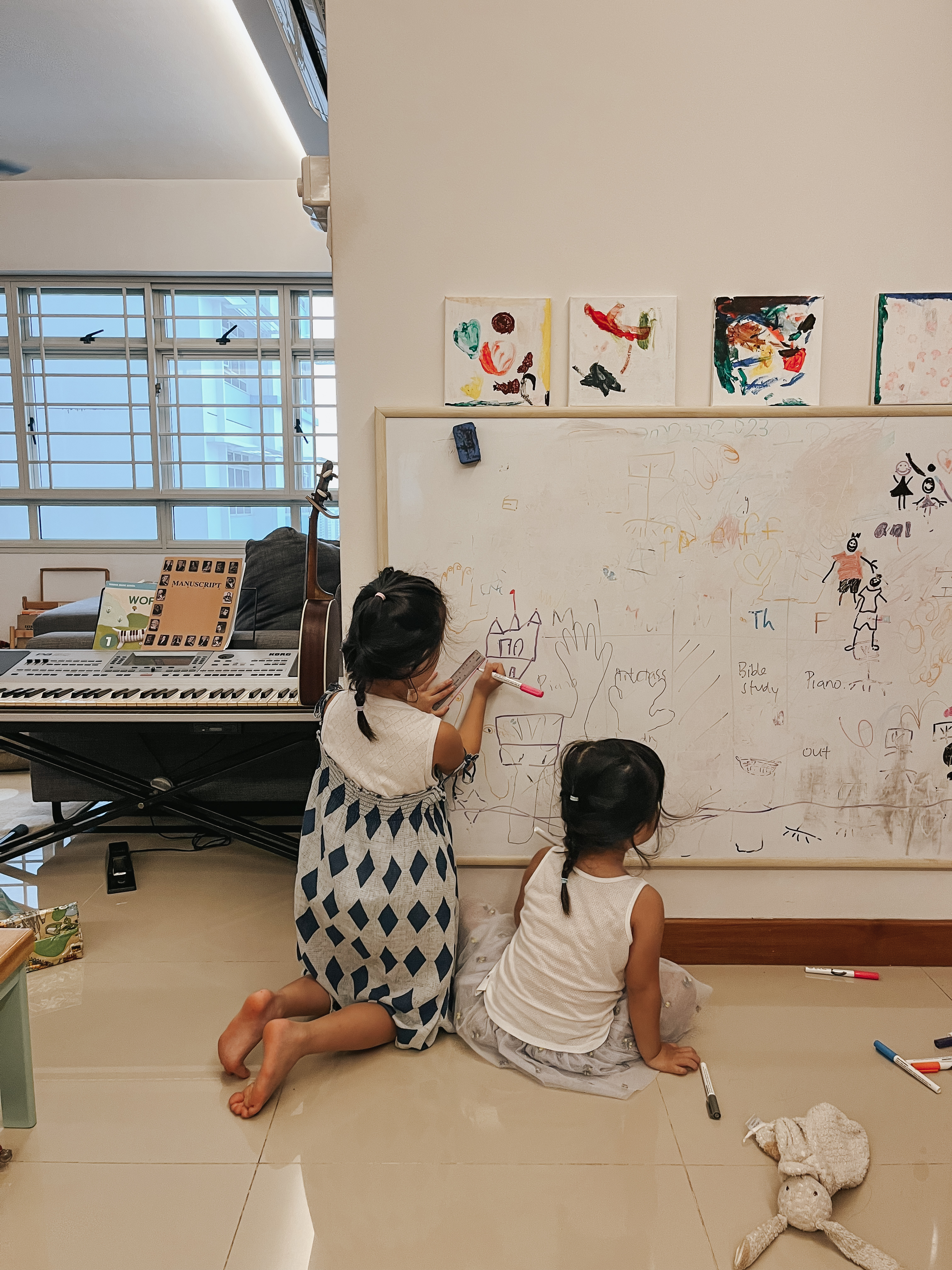 Home Tour: What a flat in Seng Kang looks like 8 years after reno - Children drawing on a whiteboard, two girls sitting on