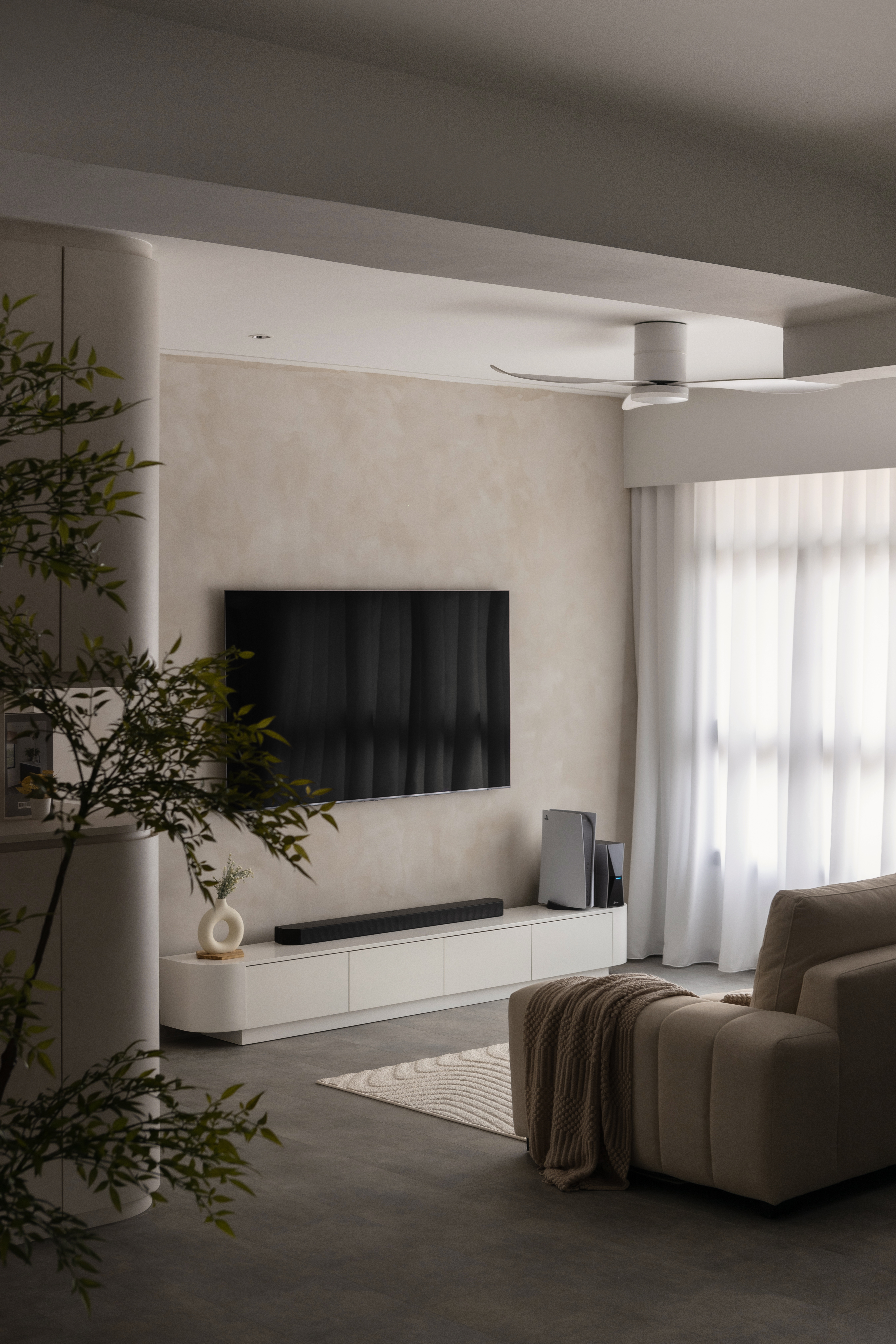 Welcome to Our Modern Wabi Sabi Haven at @ourtengahaus - Modern minimalist living room, sleek ceiling fan, large flat-screen