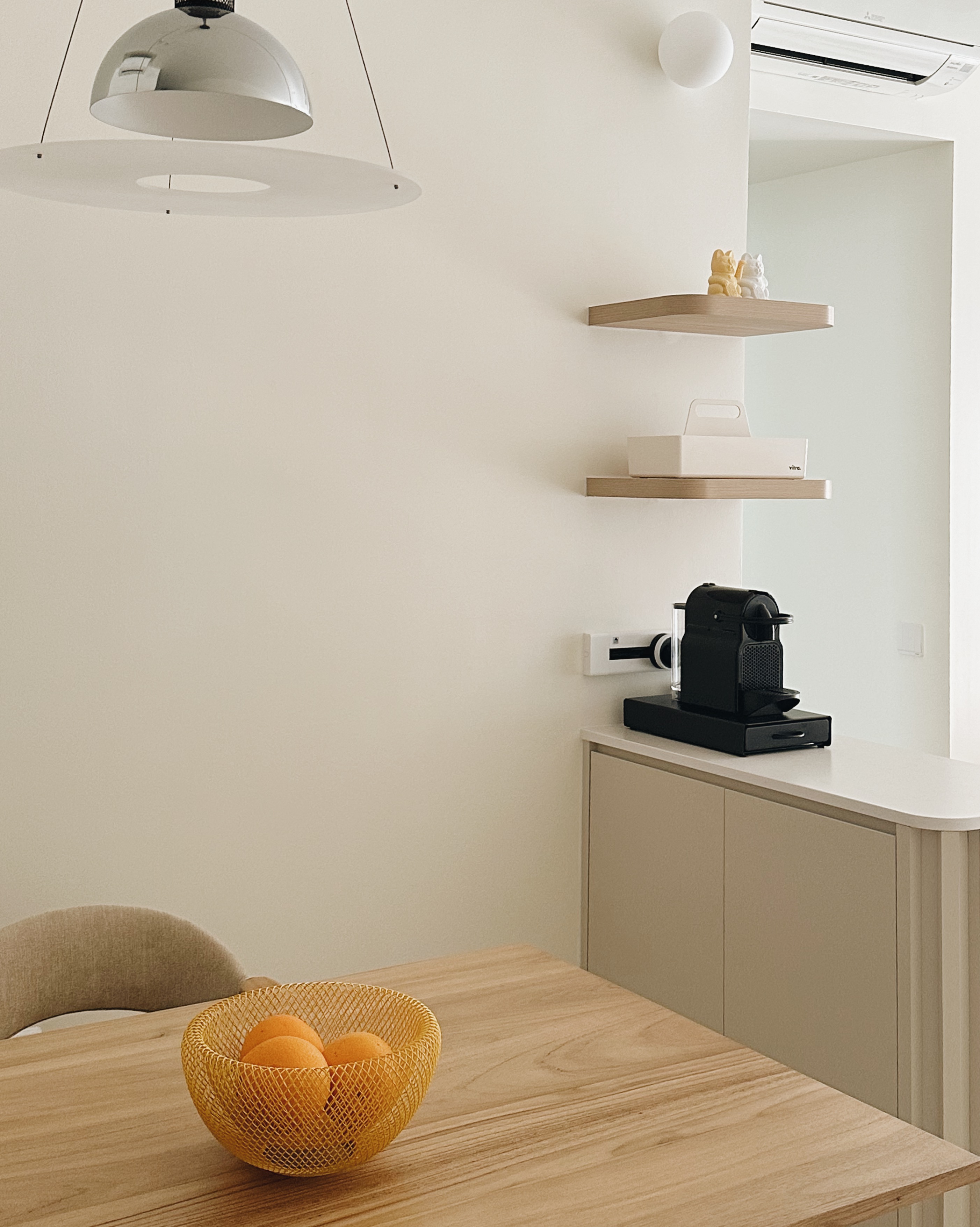 Inside a Warm Minimalist 3-Bedder Condo - Modern minimalist kitchen, neutral color palette, sleek pendant light, wooden