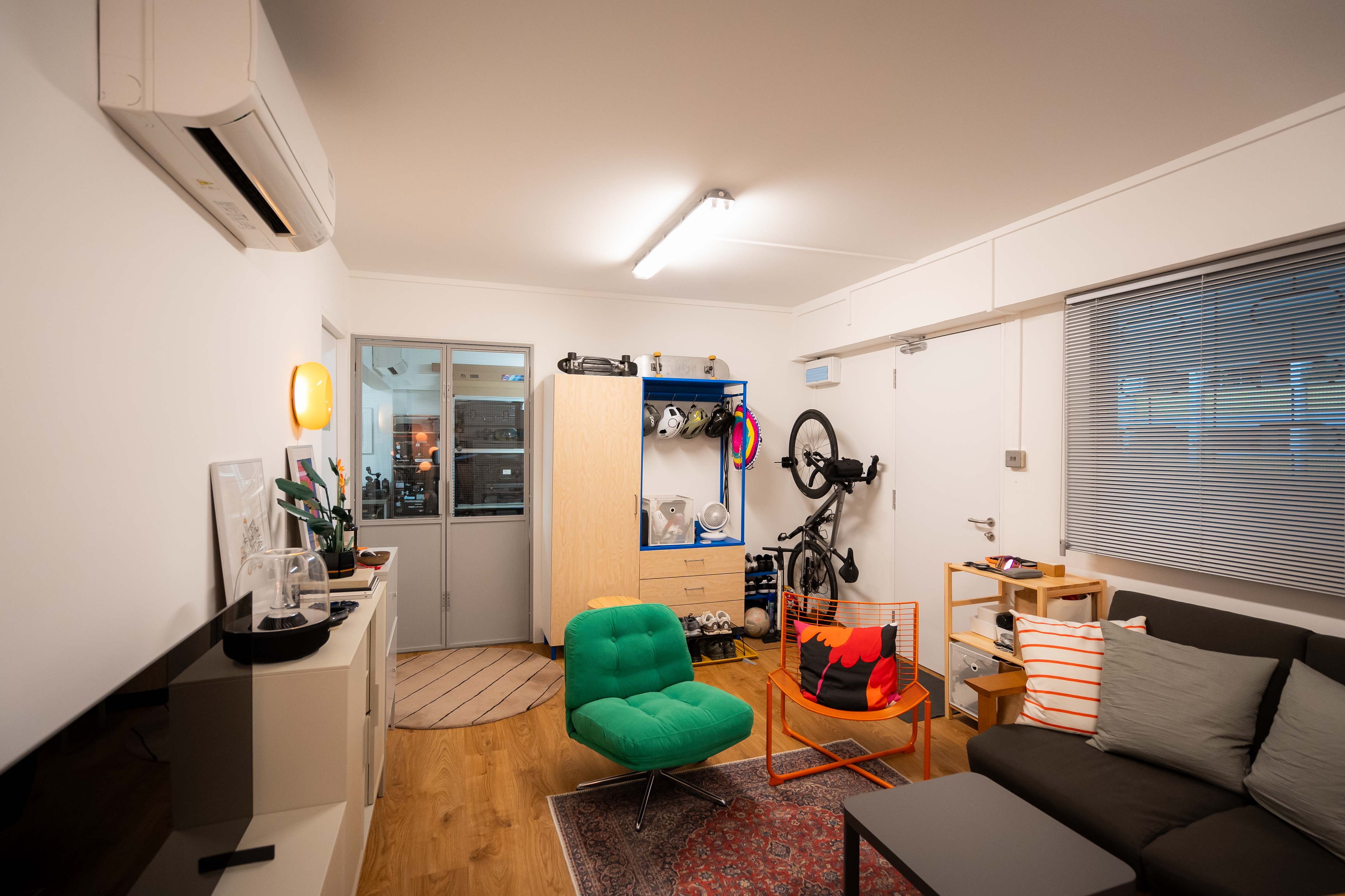 80k 4room HDB transformation: A cosy home photography studio tour! - Modern living room with green chair, orange chair