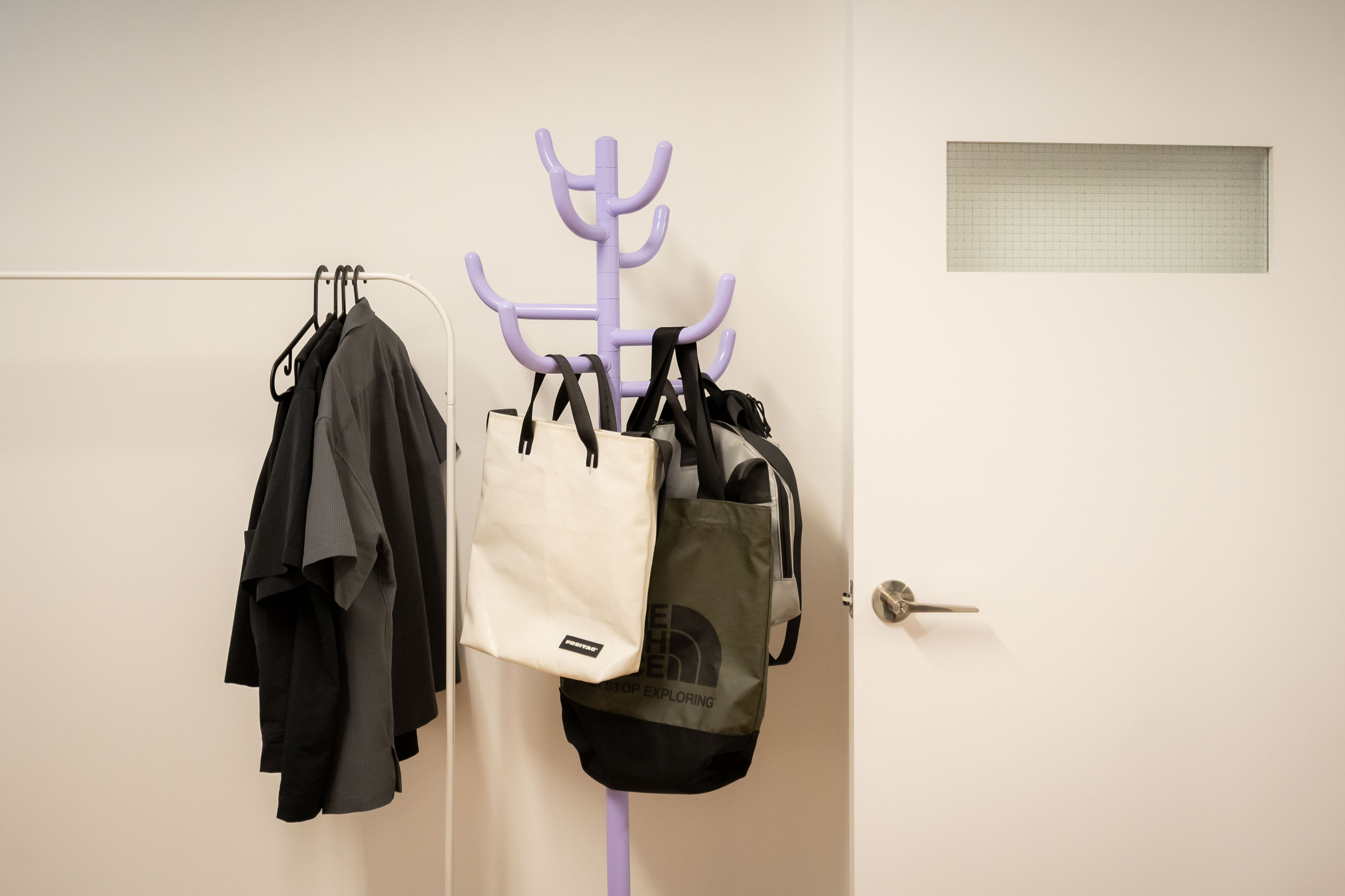 80k 4room HDB transformation: A cosy home photography studio tour! - doorway, clothing rack, hanging clothes, black coat