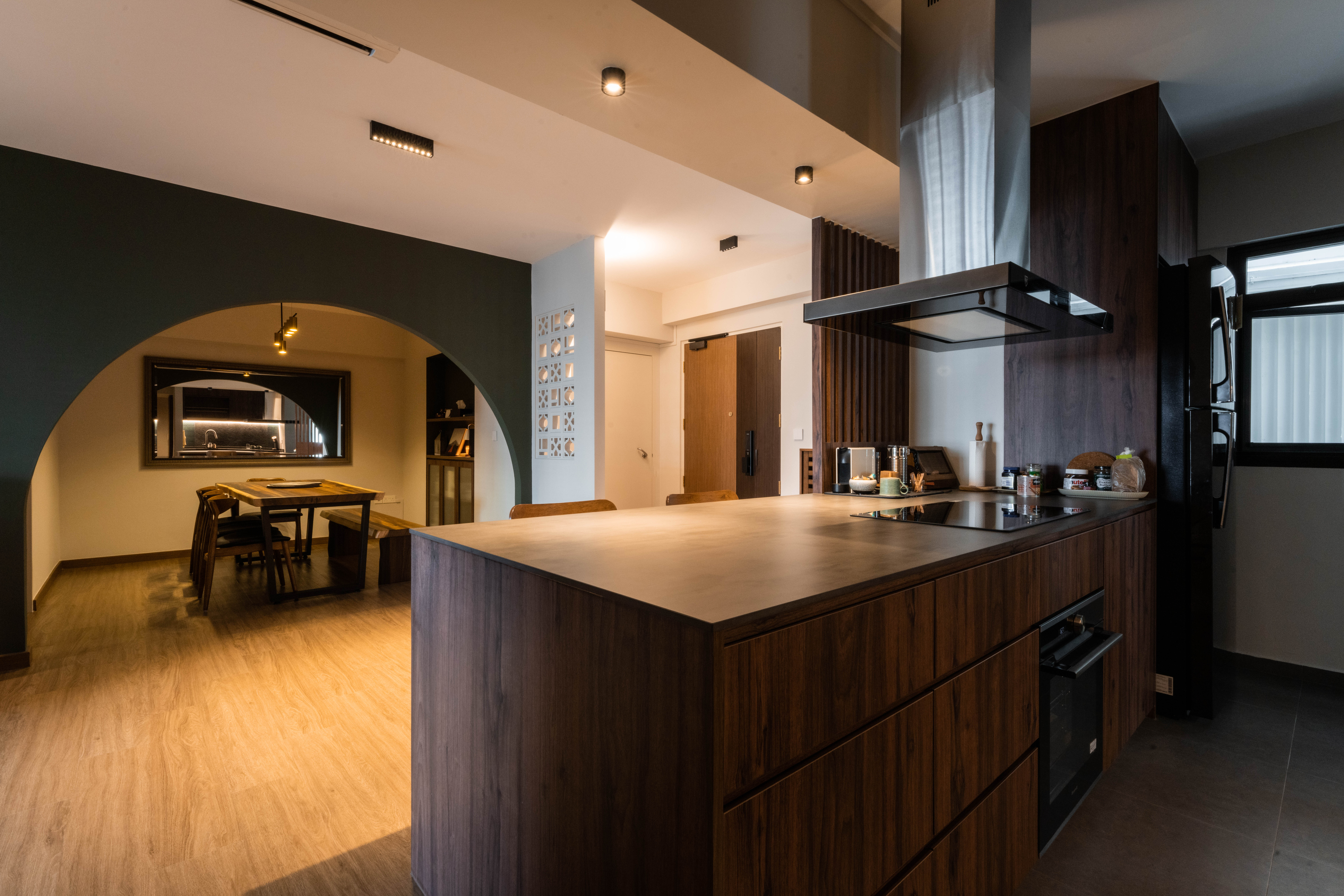 Banter and Bites - Modern kitchen with dark wood cabinetry, sleek stainless steel appliances, large island with built-in
