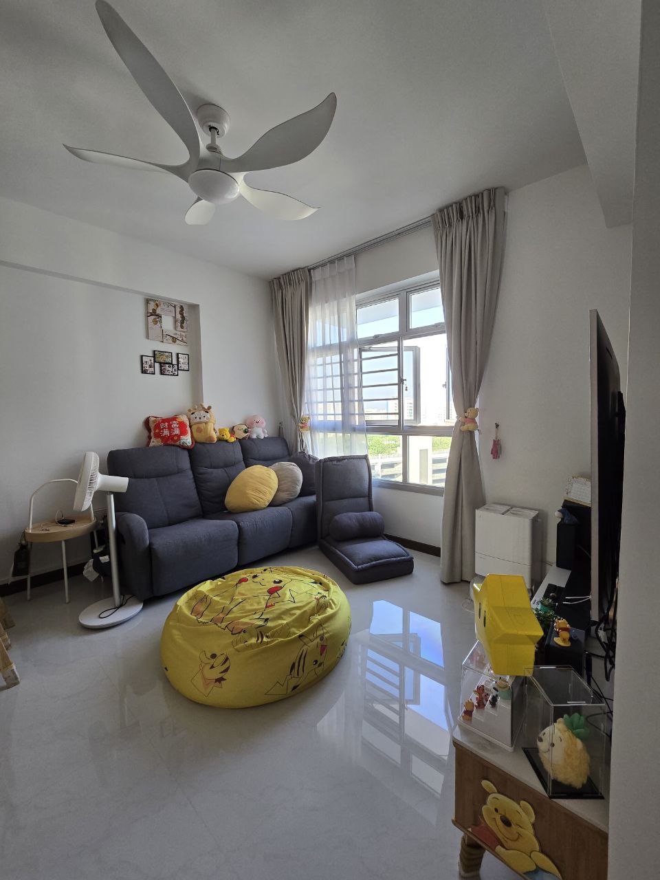 $18,000 Basic Scandinavian BTO in North - Modern living room with gray sofa, yellow bean bag, ceiling fan, large window with