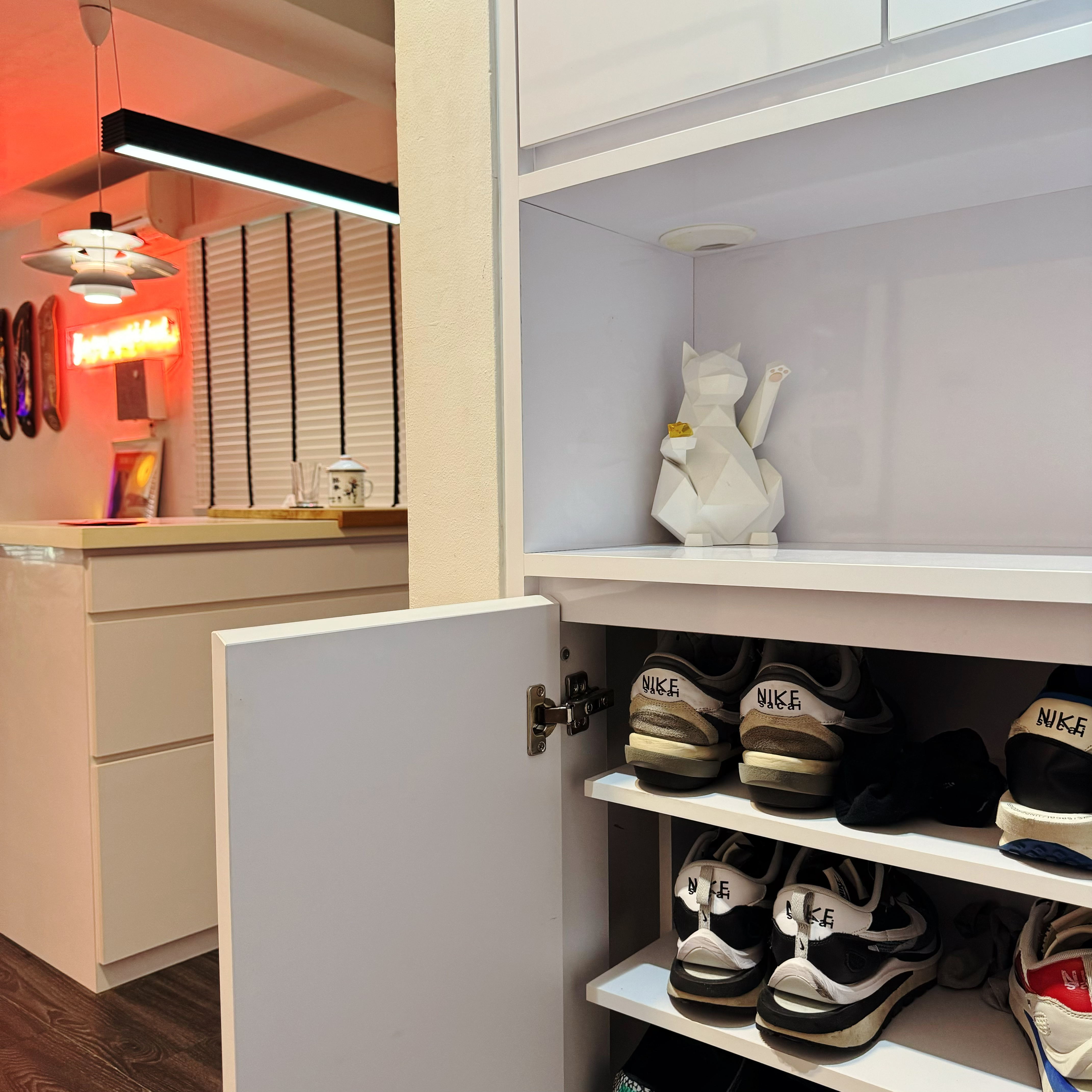 Entryway: A Minimalist and Stylish Welcome to Our Home - White shoe organizer, neatly organized sneakers, modern closet